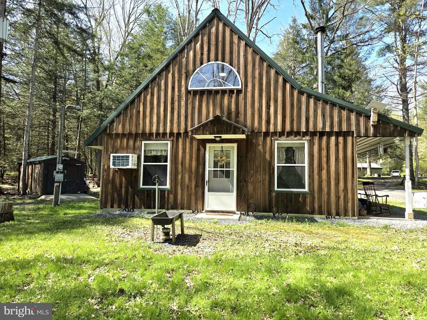Tucked away in the peaceful beauty of New Lancaster Valley, this charming 1.5-story cabin is the perfect weekend getaway, Airbnb, or basecamp for outdoor enthusiasts.

Offering 3 bedrooms, 1 full bath. This cabin has seen thoughtful upgrades that make it both comfortable and easy to enjoy. The main level features living room with wood fireplace, kitchen, 2 bedrooms, laundry, and a full bath—everything you need! Features a newly finished, wood-accented upstairs loft that serves as a third bedroom.

Stay cozy with baseboard heat and a woodstove on a stone hearth, plus propane hookup in place for future potential. Additional updates, including a UV light system for the private well, add to the home’s overall comfort. Generator being included for reliable backup power giving peace of mind at all times, and landline and internet connections are available for modern connectivity in the mountains.  Additionally this cabin is being sold fully furnished—just bring yourself!

Step outside to enjoy evenings around the fire pit, while outdoor lighting extends your time outside on warm summer nights. Carport, storage shed, and a functional outhouse.

Located less than 5 miles from Reeds Gap State Park and access to thousands of acres of public land in Bald Eagle State Forest—this is your chance to own a true mountain escape.