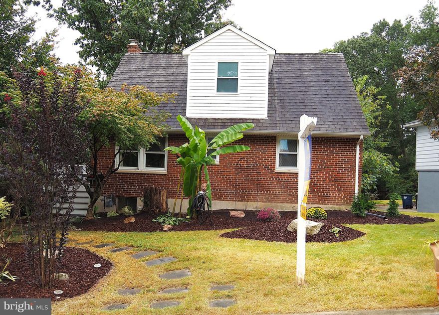 Welcome home to this charmingly updated Cape Cod, nestled in a lush, garden oasis. The main entrance is framed by a charming portico that was built in 2022. Inside, refinished hardwood floors (2019) lead through a warm and inviting living room anchored by a wall of picture windows (replaced 2025) overlooking the backyard garden, and a wood burning fireplace. A patio door leads to one of the newly renovated outdoor composite decks where you can sit and enjoy the serenity of your expansive outdoor space. The kitchen is a standout, featuring granite countertops, stylish backsplash and built in shelving. A thoughtful pass-through window connects the kitchen to the living room, balancing function with flow. Beyond the kitchen, a hall leads to a remodeled hall bathroom (2024) with all new tiles, tub, vanity, toilet and fixtures. It combines modern touches with functionality with built-in shelves for added storage. Further down the hall you will find two spacious bedrooms with ample closet space and windows that let in natural light. Heading upstairs, there are two additional bedrooms and another fully renovated full bath. The primary bedroom features recessed lighting, sloped ceilings, original wood paneling and built-ins creating a warm and inviting retreat with timeless charm. The second bedroom is enhanced with luxury vinyl floors (2020) and also features sloped ceilings that add architectural character and give a storybook feel to the space. The bathroom was recently remodeled (2025) with new wall and floor tiles, tub, sink, toilet, window and all new fixtures. The classic black and white palette with sleek black hexagon tiles creates a chic, boutique feel to this upgraded bathroom. A partially finished basement offers a versatile bonus area - ideal for a rec room, home office or workout space - with additional unfinished space perfect for storage, a workshop area or future expansion. The outdoor space truly shines with multiple decks that lead to a secluded backyard with mature trees and layered plants to create your own private retreat. Both side and back decks were redone in 2022 with new composite Trex planks and new railings for low maintenance upkeep. A lot of hard work was lovingly poured into the backyard, making it the oasis it is today by clearing out much of the overgrown vegetation and leveling out the yard. Other upgrades include new washer/dryer (2019), new stove hood (2019), new chimney cap (2020), and new garbage disposal (2024). Conveniently located close to public transportation, I-95 and I-495, as well as restaurants, shops and the University of Maryland, this home won’t last long! **Please View 360 Photo Tour**