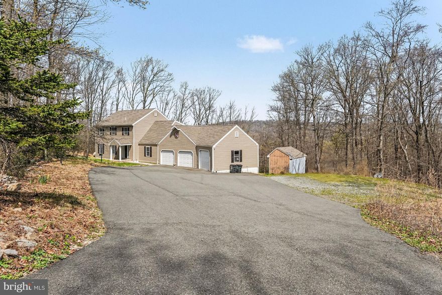 Nestled in the serene enclave of Deer Run, this Colonial-style residence offers a 2400 sq ft home, set against a backdrop of breathtaking mountain and wooded views. Spanning over 3.1 acres, the property boasts an irregular, sloping lot adorned with mature trees, creating a sanctuary that invites relaxation and tranquility.  As you step inside, you are greeted by a warm and inviting entry foyer, which flows seamlessly throughout the main living areas. The kitchen is equipped with appliances, including a self-cleaning oven and  dishwasher as well as butcher block counters, ensuring both functionality and style. The home offers four generously sized bedrooms, each designed to provide a peaceful retreat. The primary suite features a full bath with a stall shower. Additional interior highlights include ceiling fans for year-round comfort, and a attic/house fan for efficient air circulation. Step outside to discover an oversize  deck ideal for savoring morning coffee or evening sunsets while surrounded by nature's beauty. The exterior is thoughtfully designed with exterior lighting that enhances the home's charm and safety. A spacious attached garage with inside access and an oversized design provides ample parking and storage options, complemented by an asphalt driveway for easy access. The partially finished walkout basement offers endless possibilities, whether you envision a recreation room, home gym, or additional storage space. A charming shed on the property adds to the functionality, providing extra storage for gardening tools or outdoor equipment. This residence is not just a home; it embodies an exclusive lifestyle where luxury meets nature. With its stunning views and expansive lot.. This property is a rare gem that promises a life of comfort and elegance. Experience the perfect blend of indoor and outdoor living in this remarkable Deer Run retreat. The home has a mini split system which services the home to provide air conditioning for summer as well as an additional heat source during winter months, a Generac whole house generator also services the home.