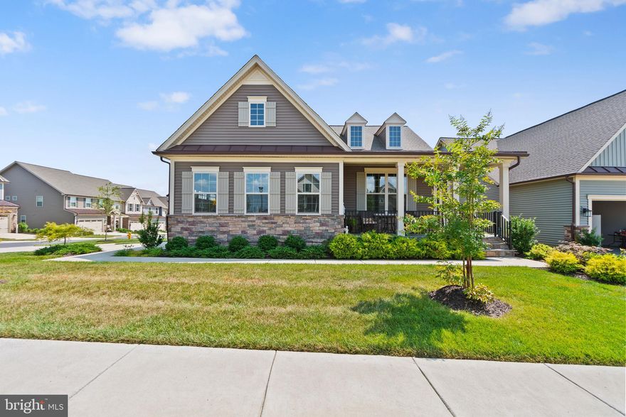 Welcome to this elegant  home, just 3 years young, nestled in the highly desirable active adult community of The Woodlands at Urbana (55+).

This vibrant neighborhood and clubhouse are filled with activities and amenities, including swimming pools, walking trails, dog parks, grandchildren playground, a state-of-the-art fitness center, golf simulator, pickleball, and bocci courts—all just minutes from major highways, shopping centers, and top-rated restaurants.

This beautiful Albright model by NV Homes offers 3 spacious bedrooms and 3 full bathrooms, with thoughtful design and luxury finishes throughout.
The main level features an open-concept layout with a modern kitchen, a large Carrera quartz island, upgraded cabinetry, and a cozy two-sided fireplace. Elegant touches such as crown molding and chair rail add charm and sophistication.
The primary suite is located on the main level, offering a large bedroom and a gorgeous primary bathroom with double sinks. This level also includes an additional bedroom and a convenient laundry room on the main floor.

The custom-finished basement is impressively spacious and perfect for entertaining, with a large recreation area, a third bedroom, a full bathroom, and a bonus room ideal as a home office, den, or guest suite. There’s even space ready to add a kitchenette, making it perfect for a mother/daughter suite or extended living space.

Enjoy the outdoors with a beautiful stone patio that connects to a double deck, featuring a screened-in porch with the double-sided fireplace—perfect for year-round enjoyment.

Located within walking distance to local eateries, this home combines luxury, comfort, and convenience in one of the most sought-after 55+ communities in the area.

The garage is finished, painted, with epoxy flooring, EV hook-up, and extra outlets for that extra refrigerator/freezer.

If you’re looking for an active adult lifestyle filled with amenities, this is the home for you.
