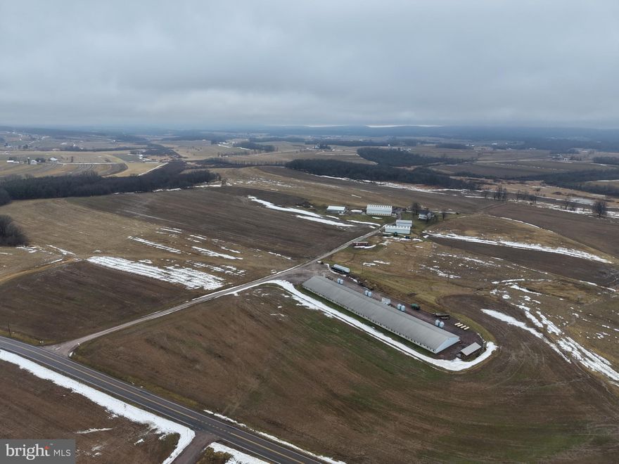 EXCELLENT 260± ACRE FARM WITH A HOG NURSERY IN SOMERSET COUNTY, PA! This outstanding 260± acre property offers approximately 170 acres of tillable ground and an exceptional combination of agricultural and residential improvements. A 9,600-head hog nursery, constructed in 2022, is currently under contract with the producer. The existing contract must be assumed by the buyer and runs for an additional 9 years, providing long-term income potential. Additional outbuildings include a 48x80 heated dog kennel building with numerous potential alternative uses, 40x80 and 32x64 equipment sheds, and a 60x110 bank barn, offering ample storage and versatility for a wide range of farm operations. The farmhouse features 5 bedrooms and 4 full bathrooms, a spacious living room, an updated kitchen with new cabinets and countertops, a large dining area, laundry room, finished basement with office space, attic, and more. The home has seen extensive updates, including a new roof, soffit, windows, doors, electrical, plumbing, and additional improvements. Heating options include efficient heat pumps or a coal stove located in the dog kennel, which provides heat to both the kennel and the residence. The property is supported by three wells, additionally, 9.6 acres are enrolled in the CREP program, set to expire in 10 years. This is an outstanding turnkey farm opportunity ready for future owners! The property is convenient to Somerset, PA, the PA turnpike and US 219.