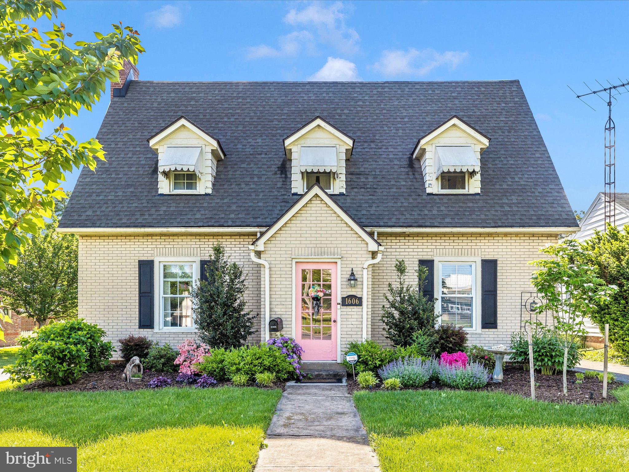 Welcome to 1606 N Market St. Perfectly situated on a lush, manicured lot with mature trees and stunning curb appeal. The inviting front walkway leads you to a charming pink front door, setting the tone for the warmth and character that await inside.
The backyard is an entertainer's dream, featuring a screened-in porch, a spacious patio area, and beautifully manicured gardens. It's the perfect spot for summer BBQs, morning coffee, or simply enjoying the outdoors in your private retreat. Additional highlights include a private driveway, attached garage, and mature landscaping that enhances the curb appeal.
Conveniently located near local shops, dining, and historic downtown Frederick, this home offers the perfect blend of character, comfort, and location.