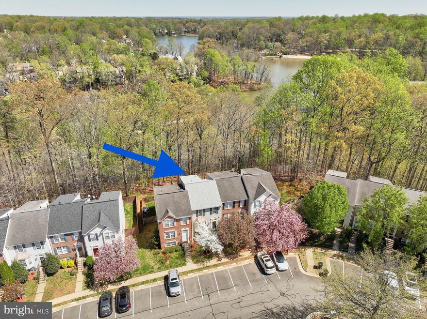 OPEN HOUSE CANCELLED. This home is under contract.   Is there anything better than lakeside living? Don't miss this RARE chance to live that lakeside life! The daily joy of  the lake view through the tranquil trees, taking a walk on the shoreline or going for a kayak ride. The deck optimizes your view while the lower level patio resides within the fully-fenced backyard. Life inside is just as breathtaking as the outside. Experience the luxury of s p a c e. This large townhome features a three-level bumpout affording a stunningly remodeled (March 2025) primary bathroom, a sunsplashed sunroom/breakfast room and a 4th bedroom with a fireplace. Another luxury? Knowing the major items of your home are less than 2 years old: Architectural grade shingles on the new roof, Trane HVAC and the gas hot water heater. All new in 2023!