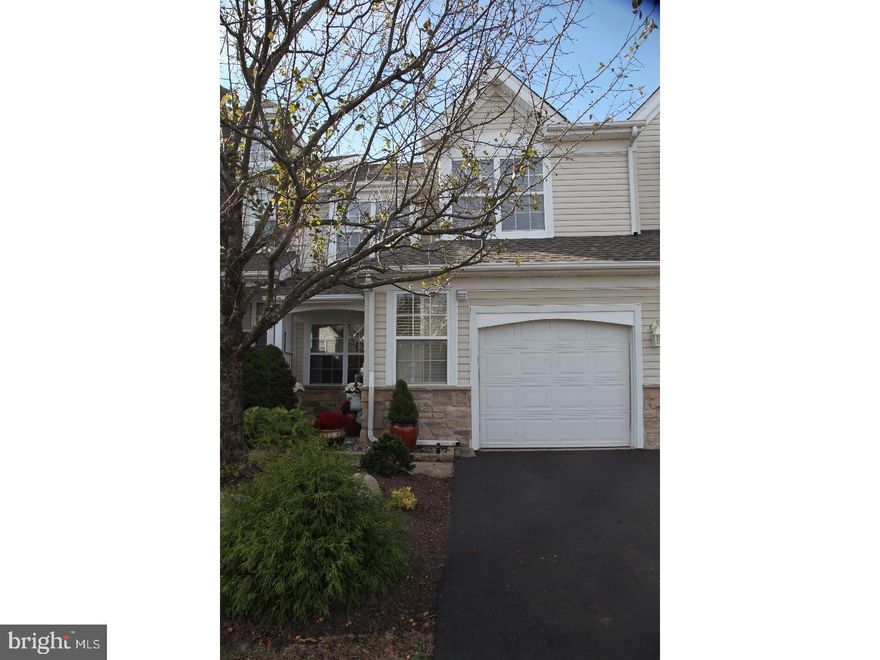 Beautiful townhome in the desirable community of Windrush. This 3 bedroom, 2.5 bath home has a newer kitchen with custom eat-in island and cabinetry, bright skylights, Bosch gas cooktop and oven, built in SubZero refrigerator and granite countertops. The living room is airy and spacious, offering foyer and garage entry, a downstairs powder room, and an open concept to the cozy dining room. The dining room flows seamlessly into the kitchen and family room areas.  Adjoined by a half-wall partition, the kitchen and family room are drenched in natural light from skylights and large windows lining the rear of the house.  These welcoming rooms overlook the oversized fenced-in patio, which backs up to a large, tree-lined yard for plenty of privacy. The family room features a gas fireplace surrounded by elegant marble opposite a peek into the upstairs of the house.  The upstairs master bedroom is enormous and sunny with a sitting area perfect for vanity/dressing, a working area, or even a nursery.  The sitting area features custom built-in floor-to-ceiling cabinetry, and complements a walk-in closet and a peaceful master bathroom with large standing/sitting shower, separate spa tub, and double sink. The upstairs hall is lined with ample storage closet space, as well as a full hall bath that serves two spacious bedrooms each with their own large windows and roomy closets.  All bathrooms have been recently renovated. This home is conveniently located near parks, shopping, and just minutes from Doylestown and in the award-winning Central Bucks School District. Showings begin at Open House scheduled for 11/2/25.