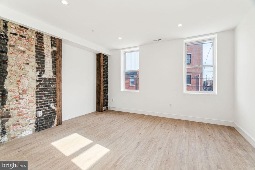 Experience the perfect blend of historic charm and modern comfort in this brand-new, never-before-occupied 1-bedroom, 1-bathroom residence at 1254-6 S 18th St, Unit 1, located in a beautifully renovated and converted building on the corner of 18th and Wharton. Retaining its original wood and brick detailing, this thoughtfully designed unit features high ceilings, durable luxury vinyl floors, and an open-concept living area highlighted by exposed brick from the former passageway between the previously conjoined buildings. The well-appointed kitchen is neatly tucked away, featuring walnut cabinets, quartz countertops, ceramic tile backsplashes, stainless steel appliances, gas cooking, a garbage disposal, and high-efficiency hot water on demand. The spacious bedroom offers two large closets and oversized south-facing windows that flood the space with sunlight all day long, while the sleek bathroom includes a combination tub/shower and clean ceramic tiling. Additional conveniences include in-unit laundry, an electronic door code entry system, a bike room, and pet-friendly accommodations (maximum of 2 pets, 1 dog up to 50 lbs). Ideally located in vibrant Point Breeze, this home is nestled between the Ellsworth-Federal and Tasker-Morris BSL stops, just steps from exciting new restaurants and local favorites like American Sardine Bar. Plus, head straight down 18th Street, and you'll find yourself in the heart of Center City. Don’t miss the chance to be the first to call this stunning space home!