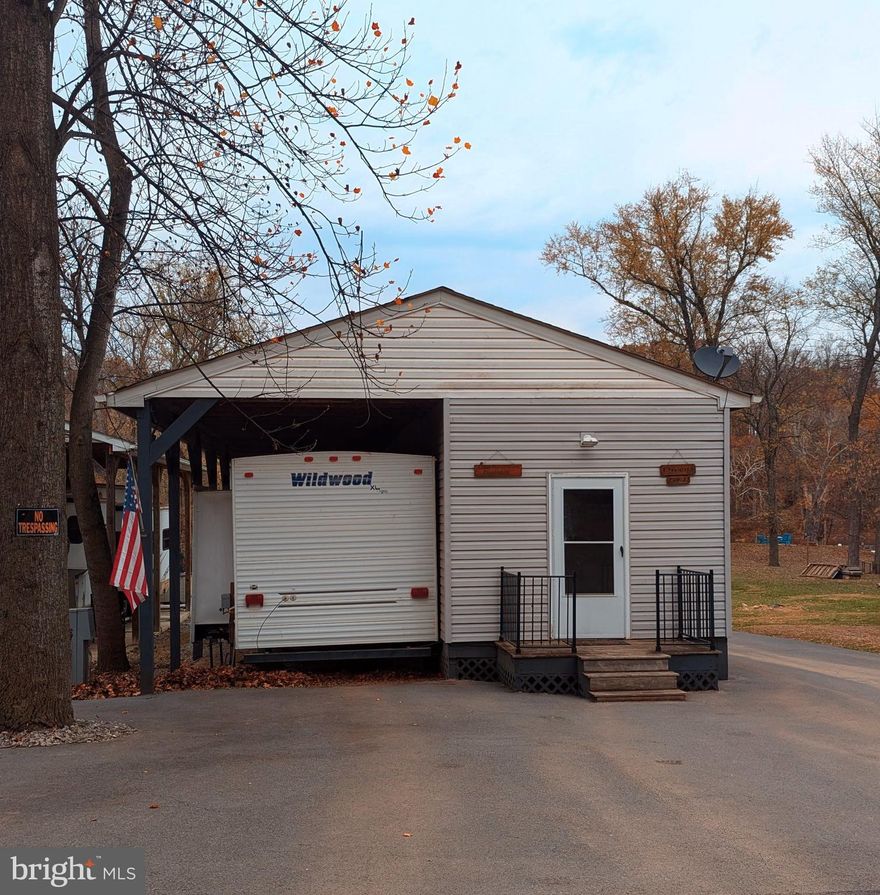 This is a gated community so you need to enter at the guard shack. Entry is not permitted without ID per the office rules. Bring ID's to the office or guard shack for visitor pass. THIS IS A SEASONAL CAMPGROUND! OPEN FROM APRIL 1 TO NOVEMBER 1. ** WELCOME TO RIVER BEND/SEASONAL LOT AVAILABLE TURN KEY** River Bend is a privately owned 400 acre recreational- vehicle camp resort with seasonal activities for members, families and guests. This great RV park is tucked away on the Upper Potomac River of West Virginia, River Bend is one of West Virginia's most popular family seasonal destinations. . Just a short drive from the Washington and Baltimore metro area. Open with utilities from April 1 to November 1. Lot owners have access to their property the entire year. *** Members Enjoy *** * Amazing views and wildlife, Potomac River access, Trails, Swimming pools, Mini-Golf, Youth center, Tennis and basketball courts, laundry facilities, convenience store, deli and lounge. *Bath houses through out the park, boat ramp, bar and grill and even a church located on the grounds. River Bend also hosts numerous activities such as 4th of July fire works, small carnival, bonfires, poker runs, horse shoe tournaments, car show, Halloween Trick or Treat and so much more. 
***Property Details ***
This very large lot has a lot to offer. "TURN KEY LOT"  bring your personal belongings and start the river life.  Lot comes with a 2022 Pontoon Boat Sun Tracker Bass Buggy, Ez Go Golf Cart, 2009 Forest River Travel Trailer with large windows that face the river. Camper has new living room furniture that reclines.  Riding lawn mower, large summer kitchen, table deck furniture, all appliances, great storage shed to store your items and has water and electric to the shed, metal pavilion down by the water that has electric and water as well.  Floating dock that will hold two boats, concrete steps down to get to the floating dock.  Driveway is paved for plenty of parking.  Check out this lot with your own personal water access.