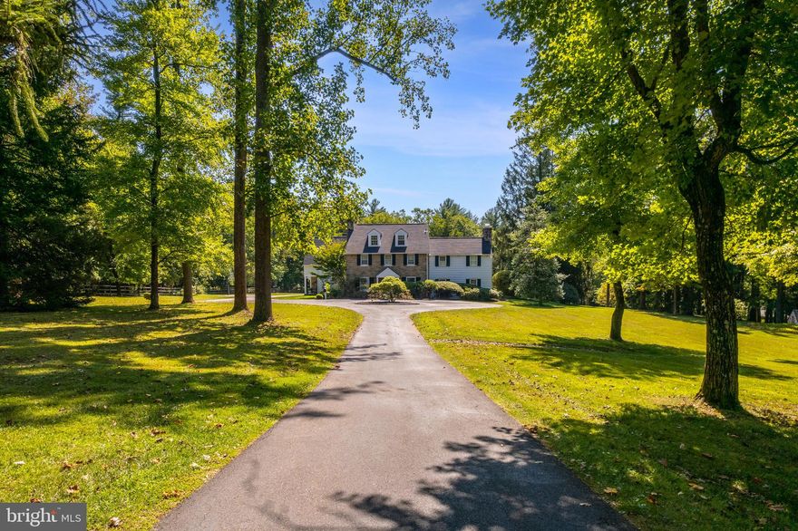 Presenting a private country retreat in the heart of Whitemarsh Township. Surrounded by large estates, and open space, including nearby Highlands and Fort Washington State Park, this 5 bedroom, 4 full and 2 half bath showstopper blends the best of traditional and Aspen-style architecture with state-of-the-art modern conveniences. Extraordinary quality and craftsmanship are showcased in the custom wood trusses, 2-story stone fireplace, custom cabinetry, granite counters, barn-wood doors, and more. The heart of this entertainer’s paradise is the sun-filled 2-story great room, with custom wood trusses, large sliding barn door, iron railings, custom chandelier and grand, 2-story stone fireplace, flanked by French doors that open to the rear grounds. The large, open chef’s kitchen features an expansive center island and leathered granite counters, farmhouse sink, Thermador 6-burner range with pot filler and stone surround, double Thermador ovens, Miele coffee station with beverage fridge, and walk-in pantry. An open dining area and large, custom-hewn bar area with beverage fridge and ample cabinetry make the open first floor concept an entertainer’s dream. Numerous sets of French doors step out to the slate terrace, with built-in firepit and large covered area with built-in BBQ, perfect for al fresco dining. The main floor also includes a cozy den with fireplace, 2 powder rooms, living room, and large family entrance with mudroom, extra-large closet, and the first of two laundries. The primary bedroom suite features a large, open office area overlooking the great room, dual walk-in closets, and large bath with radiant floors and walk-in, stone-tiled shower. An expansive balcony overlooking the great room leads to 3 secondary bedrooms, one with ensuite bath, a full hall bath and the second floor laundry room. The third floor offers the fifth bedroom, walk-in closet and full bath. The lower level offers a large, unfinished bonus space and ample storage. An oversized, 3-car garage and separate, 1 bedroom cottage with 2 additional garage bays completes this fantastic property. Set in a superlative location with easy access to local shops and dining, major roads, Flourtown and Chestnut Hill.