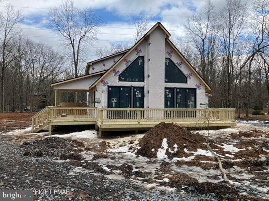 Ready for Spring 2026 - Stunning spacious chalet with open floor plan, upgraded features like granite counters, stainless appliances, electric fireplace, laminate flooring, attached garage and open loft. Under construction now with target finish date April, 2026. Property backs to green area. House located in much-sought-after Towamensing Trails community with large lake, pool, clubhouse, bar, restaurant, boat docks. STR-friendly.