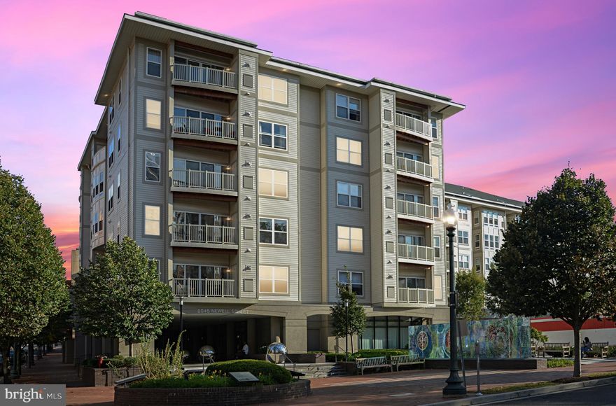 Welcome to the top floor of 8045 Newell Street—where location, luxury, and lifestyle come together in the most desirable way. This one-bedroom plus den condo offers unparalleled views of the surrounding neighborhoods with sweeping sunsets that you can enjoy from your private balcony. Located in one of the building’s most sought-after spots, this unit truly stands out.

Inside, you’ll find a bright and open layout perfect for both relaxing and entertaining. The kitchen features granite countertops and overlooks the spacious living area, making it the heart of the home. Unlike other units in the building, this one is upgraded with beautiful hardwood floors that add warmth and style throughout.

The versatile den offers the flexibility of a home office or guest space and also includes a sizeable closet providing extra space for the homeowner, while the primary bedroom boasts a generous walk-in closet for all your storage needs.

A reserved garage parking space makes commuting a breeze, and you’re just steps to the Metro, MARC, and the future Purple Line. This pet-friendly, smoke-free building includes top-tier amenities such as a fitness center, resident lounge, and an inviting outdoor patio.

With a Walk Score of 94, you’re in the center of it all—walk to Giant, Whole Foods, Target, Ellsworth Place, farmer’s markets, restaurants, and more. Don’t miss this rare opportunity to own a top-floor unit with unbeatable views, premium finishes, and one of the best locations in the building!