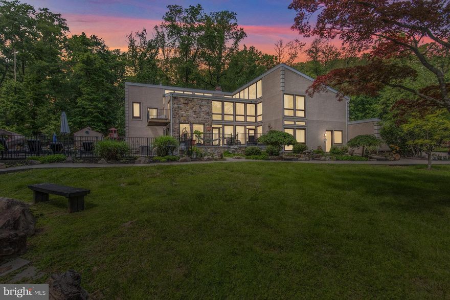 Exceptional 7-bedroom, 6.5-bath single-family home including a spacious in-law suite and resort-style amenities. Enjoy the perfect blend of privacy, comfort, and luxury—ideal for extended families or hosting guests. This unique property spans over 2 separate parcels, totaling more than 2 acres of gated property—a true one-of-a-kind estate. Upper Moreland School District. Conveniently close to shopping (Willow Grove Mall) and just 1.5 Miles from the commuter station, also close to Huntingdon Valley Country Club, Abington Hospital and Pennypack Park Trail to name a few.  Upon entering the home through the front gated patio, you're welcomed into a stunning two-story living room filled with natural light. This space features hardwood floors, a wood-burning fireplace, exposed brick accents, and recessed lighting. Just off the living room, you'll find a sunken formal dining room showcasing an exposed brick wall, a decorative chandelier, and beautiful views overlooking the expansive pool area. The spacious eat-in kitchen offers ample cabinetry, counter space and countertops, along with recessed lighting, and a full suite of stainless steel appliances including a refrigerator, dishwasher, microwave, and range. A wall of windows with a sliding glass door leads directly to the rear yard, perfect for indoor-outdoor living. The kitchen also includes a large pantry, an additional storage closet, and access to the crawlspace. A second dining room provides even more entertaining space, featuring French doors that open directly to the backyard. Continuing through the main level, you'll find a large sunken piano room with gleaming hardwood floors and large windows. A beautifully updated oversized powder room with oversized vanity and decorative mirror with sconces. Heading toward the back of the home are elaborate French doors leading to the backyard. Also featured on the level is another generously sized bedroom including a full bath, hardwood floors, and a closet in addition to the flexible living space ideal for a private in-law suite or multi-generational living. This area features a private entrance, a comfortable living area with interior access to the two-car garage, hardwood floors, and a spacious bedroom with a full bath, recessed lighting, ceramic tile, and ample closet space. The upper level of the home overlooks the main living area. The primary suite side of the upper level features wall-to-wall carpeting, vaulted ceilings, recessed lighting, a large closet, and a sliding door that opens to a private balcony. The spa-like primary bathroom includes a Jacuzzi tub with shower and plenty of bells and whistles, elegant custom ceramic tile, an oversized vanity, and a stylish decorative bowl sink. Adjacent to the primary suite is a large private sitting room with hardwood floors and its own deck. The upper level also includes 4 additional generously sized bedrooms, each with wall-to-wall carpeting, vaulted ceilings, and ample closet space. A large hall bathroom features ceramic tile flooring, a double vanity, and a double shower. Completing the upper level is a spacious open area with hardwood floors, perfect for use as a playroom, office, library, or study. Perfectly set back from the road, the property welcomes you with a massive driveway, two tranquil ponds, an in-ground pool, hot tub, a children’s playground, and a scenic walkway that circles the grounds—ideal for peaceful evening strolls. Outdoor living is truly elevated here with a fully equipped eat-in outdoor kitchen, complete with a wet bar, center island with stainless steel sink, wine rack, ample cabinetry, stove, microwave, flat-top grill, fryer, recessed lighting and built-in surround sound. No need to head inside—2 full outdoor bathrooms (the 6th and 7th baths), each with a three-piece layout (stall showers), provide added convenience for pool days. Additional features include a whole-house generator, two-zone HVAC system, roof from 2023 & 20+ car parking.