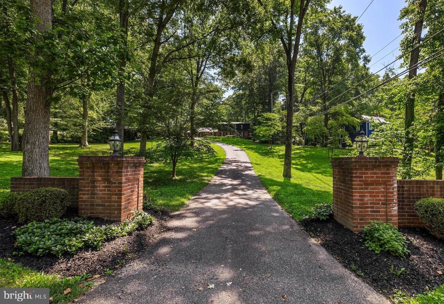 "Summer Hill" .. As you drive into the stately entrance to this Impressive Dutch Colonial, you are welcomed by gorgeous red brick pillars on either side of the driveway and a charming  150 year-old stone spring house with historical roots that adds character and flair to the 1.2 acre property.  Azaleas and holly shrubs line both sides of the brick walkway leading to the front door. This home offers a gorgeous kitchen with quartz countertops perfect for entertaining, an exquisite expanded family room with lofty high ceilings, beautiful beams and a cozy wood burning fireplace, butlers pantry with a beverage refrigerator for entertaining, an inviting wraparound deck  surrounded by lush level landscaping for entertaining. The primary suite on the main level offers a fitted walk in closet and laundry closet plus a sitting room with French doors leading out to a brick patio. The upstairs offers another primary suite and 3 additional bedrooms and hall bath with laundry. The lower level fully finished recreation room with handsome built-ins, bar w/dishwasher and full bath.  An oversized double car garage featuring a pulldown staircase leading to an upstairs attic with plenty of storage space. Close proximity to the NCR trail and Hunt Valley shops and restaurants make this the perfect home in one of the most desirable locations in the Baltimore area.