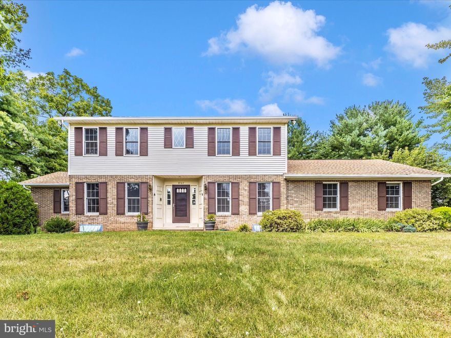 Step into a spacious 4-bedroom, 3.5-bath home offering over 2,350 sq ft of finished living area over two gracious levels, with a basement adding additional functional space. This classic brick Colonial, built in 1975, blends traditional charm with modern updates. The main level features a convenient bedroom with an en-suite full-bath—a perfect option for guests or multigenerational living. A cozy two-story brick fireplace anchors the family room, offering a focal point for gatherings. Enjoy the comfort of all new carpet paired with stylish tile and timeless hardwood flooring. Upstairs, three well-sized bedrooms include two full bathrooms and a soothing primary suite. The side-entry two-car garage and driveway parking make access effortless.