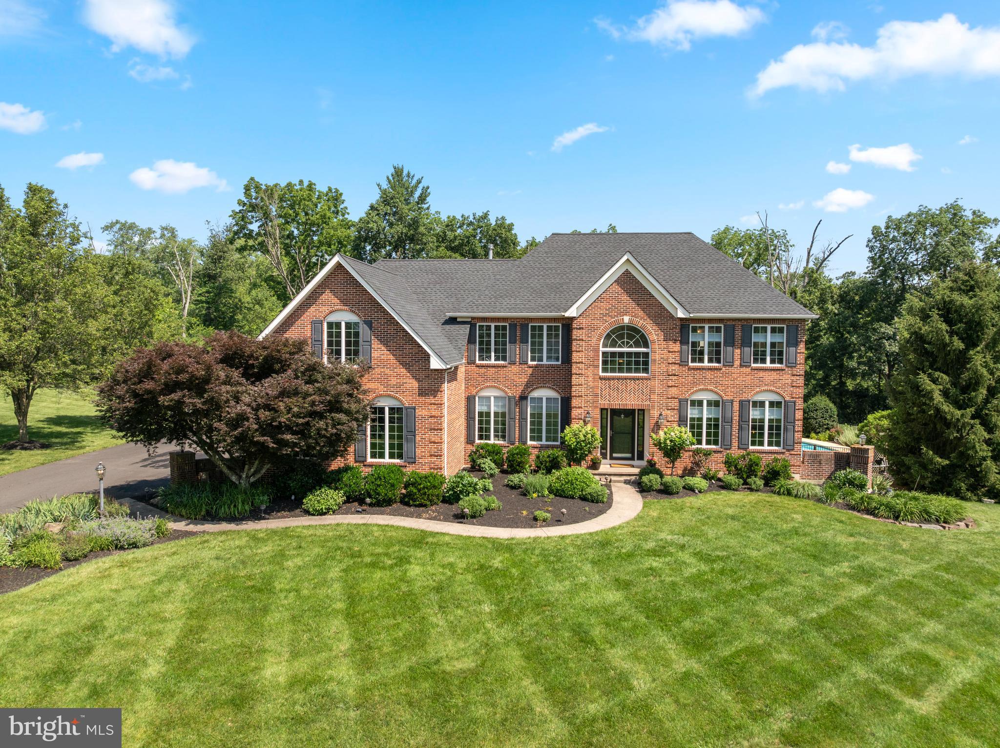 Elegant brick Colonial on 1.84 acres in sought-after Souderton School District
Nestled at the end of a quiet cul-de-sac in one of Harleysville’s most desirable neighborhoods, 845 April Hill Way offers a rare opportunity to own a meticulously maintained brick colonial set on 1.84 lush acres.
From the moment you step into the grand two-story foyer, you’ll be captivated by the home’s timeless elegance and thoughtful design. The main level features a private home office, a formal sitting room, and a gracious dining room ideal for hosting gatherings. The expansive kitchen is a chef’s dream, complete with granite countertops, a gas cooktop, a center island with seating and additional storage, a walk-in pantry, built-in recipe desk, and a sunny breakfast room. The heart of the home is the stunning two-story great room, anchored by a floor-to-ceiling wood-burning fireplace that creates a warm and inviting atmosphere.
Conveniently located off the kitchen is a spacious mudroom/laundry area with a utility sink and direct access to the oversized three-car garage.
Upstairs, the luxurious primary suite impresses with vaulted ceilings, a large walk-in closet, a secondary closet, and a spa-like en suite bath featuring a soaking tub and separate shower. The second bedroom includes its own private en suite bath, while the third and fourth bedrooms share a well-appointed Jack-and-Jill bathroom.
With over 3,600 square feet of above-grade living space and an additional 1,100 square feet of finished basement, this home offers exceptional versatility. The basement is designed for both relaxation and entertainment, featuring a playroom, a comfortable living area, a full bathroom, a wet bar, and ample storage.
Step outside to experience a backyard oasis designed for entertaining. The expansive outdoor living area includes a full kitchen with a gas grill, sink, built-in mini fridge, and storage, as well as a cozy seating area with a gas fireplace, mounted outdoor TV, pergola, and retractable awning. The in-ground swimming pool is surrounded by mature, professionally landscaped grounds that provide beauty and privacy.
Pride of ownership shines throughout, with over two decades of thoughtful upgrades and maintenance, including:
2004 – In-ground swimming pool installation
2004 – Outdoor patio and living area addition
2006 – Hardwood flooring throughout main and second floors
2007 – Finished basement with full bathroom and wet bar
2008 – Primary bathroom renovation
2017 – HVAC system replacement (single-unit)
2019 – New garage doors
2024 – Driveway resurfacing
2025 – Total roof reshingling
2025 – New rear patio door
2025 – Fresh paint throughout main and second floors
2025- HVAC system replacement (second-unit)
This is a rare opportunity to own a turn-key estate home in an established community with easy access to local amenities, shopping, dining, and major routes. Schedule your private showing today and experience the exceptional lifestyle that awaits at 845 April Hill Way.