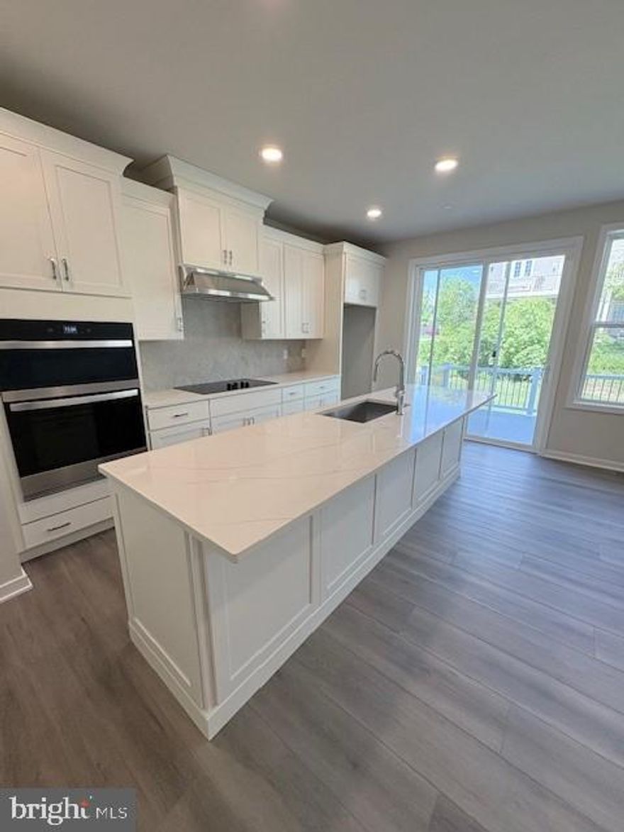 Move-in ready! You'll  feel right at home in this Carisbrooke floorplan. Enter from your private side-door entrance. Current photos are of the model, the actual home has a beautiful white kitchen with white veined quartz countertops and an oversized island with cabinets on both sides and a gourmet kitchen! Large deck with ample back yard space. Highlighting the elegant primary bedroom suite is a large walk-in closet and beautiful primary bath with dual-sink vanity, luxe shower, and private water closet. Secondary bedrooms feature generous closets and shared hall bath. Additional highlights include a convenient main level powder room, second floor laundry, and additional storage throughout.