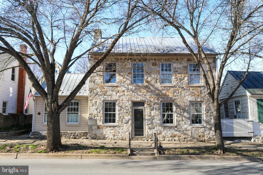 Remarkable renovation of one of Historic Sharpsburg's 18th century stone homes fronting on historic Main Street. Lovingly maintained by the present owners. Entrance is into the formal dining room with wood floors and stunning fireplace. To the left is the comfortable, sunny kitchen with exposed stone walls. To the right of the dining room is the spacious living room with a wall of custom built ins. The second level is home to two bedrooms ( one is currently used as a sitting room)., another fireplace with tiled surround and a spacious full bath. A door leads outside to the large brick terrace and access to the adjacent studio. The third floor of the house was finished as an artists loft, but is now used as a bed room. Imagine laying in bed and watching the stars at night through the large skylights. This home is truly a delight and will be an extraordinary home for the next owners. Lots of great things are happening in Sharpsburg with the new interpretive park in the center of town and the preservation of some other homes as well. Great time to move to town and be part of something big!