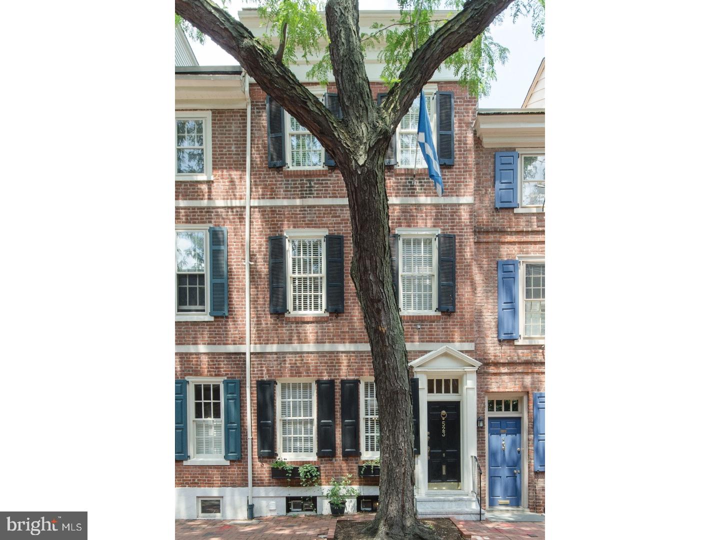 Thoughtfully updated Historic home on the desirable "Flag Block" of Society Hill's Delancey Street. Rarely found, this home is just-right - great size, 3 bedrooms plus an office/den, 2.5 baths, patio, roof deck and basement. The spacious living room has wood floors, fireplace with pretty mantle, flows into the dining room which is also open to the fully equipped kitchen with Viking Stove, Sub-Zero refrigerator/freezer, shaker style cabinets, farmhouse sink, marble counters and backsplash. Powder room on this level and side door to the large sunny patio. The second floor North is a spacious master bedroom with 3 closets - including large walk-in-closet and closet with washer and dryer hook up, a large master bath with two sinks and stall shower and Juliet balcony with slate floor. The second floor front is a sunny bedroom with windows on Delancey Street. The third floor rear has a den/office, cooking top, fridge and wet bar leading to a great rooftop deck with skyline views. Front bedroom and full bath. These homeowners have excavated and re-floored the basement to increase ceiling height and usability: the basement includes a washer/dryer. Fantastic Society Hill location close to market, coffee shops, restaurants, parks and playgrounds. Sale includes pre-paid parking spot for one year in nearby lot.