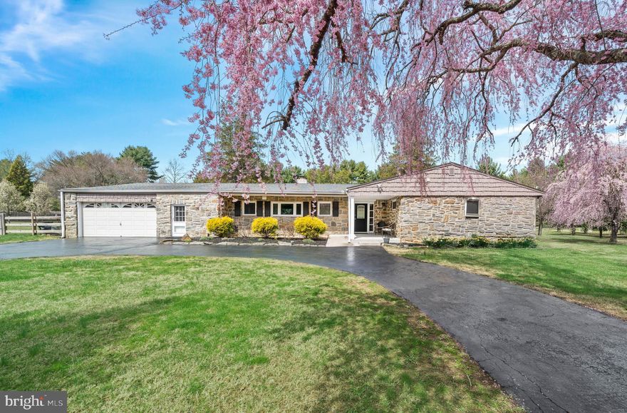 Beautiful expanded stone ranch in Garnet Valley situated on a picturesque 1.99 acre lot. Meticulously maintained and updated, this 4 Bedroom, 4 Bath home with an open floor plan and hardwood floors throughout, offers one-floor living at its finest. The thoughtfully updated Kitchen boasts granite counters, stone backsplash, abundant cabinetry, large center island with seating for 4 and custom wood counter, stainless appliances, and a pantry closet. Kitchen flows into the spacious Family Room with a stunning double-sided stone fireplace with dual custom mantels and flagstone hearth and is complemented by a triple window that showcases the spectacular, level backyard adorned with mature plantings. Adjacent to the Family Room, the large Dining Room features triple sliders that open to a covered patio, perfect for outdoor dining. This home offers two Primary Suites, one of which can easily function as an in-law or au pair suite. A beautiful addition (2018) hosts a large Bedroom with walk-in closet with custom shelving and a luxurious en suite Bath. This Bath includes radiant floors, dual sink vanity with quartz countertop, 24x12 ceramic tile flooring, and an oversized shower with floor-to-ceiling tiles, glass accents, and a seating bench. A sitting room off of this suite, which can also serve as a den, has French doors opening to a private patio that offers another gorgeous view of the yard. The second primary suite, located on the opposite side of the home, features four sets of double closets and sliders that open to a Sunroom with three walls of windows (sliders) and a stone accent wall. Its en suite  bath also has radiant floors and a fully tiled shower. Two additional generously sized Bedrooms with double closets share a hall Bath with a bathtub and new vanity.  A main floor Office, Laundry Area, and tiled Mudroom side entry with access to the two-car Garage, which includes a bump out and separate manual single door, complete this spacious level. The fully finished Lower Level offers an abundance of additional living space, featuring a dedicated Game Room, fully equipped Exercise Area, a second Office (that could serve as a fifth bedroom), a full Bath, and additional rooms/closets for storage. Additional upgrades to this incredible home include a newer roof and HVAC system(s), energy-efficient double paned replacement windows throughout, a whole-house water filtration system, handicap-accessible features (36" doorways, shower and entrance ramp), and a fully fenced yard offering endless options for outdoor fun and entertaining. Ideally situated within the highly acclaimed Garnet Valley School District, this home provides easy access to major highways, Philadelphia International Airport, and Downtown Wilmington. Schedule your appointment today  to tour this wonderful home!