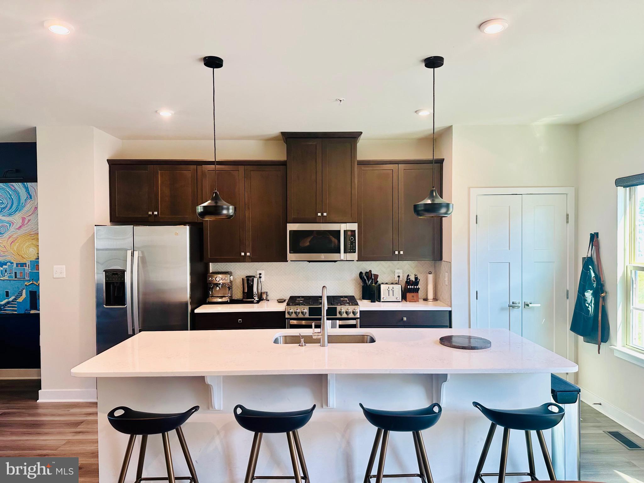 Stunning End Unit Townhome in the Bloom Village Subdivision from Ryan Homes. Just over a year old with top-of-the-line appliances, luxury vinyl flooring, gas stove, plenty of storage space, and a beautiful open floor plan for entertaining family and friends. Two unused bedrooms, entertainment room, quartz kitchen countertops, upgraded tile and shower in the main bathroom. Enjoy your morning coffee on the large deck overlooking two ponds with ample wildlife. Sunsets are incredible. An amazing deal in a quiet, peaceful neighborhood. The main floor features gorgeous upgrades including automatic blinds, herringbone backsplash, deep kitchen sink, and modern lighting. EVERYTHING NEW! Mere minutes from the local schools, grocery stores, and nature trails. Pristine condition. Move-in ready and priced to sell. All offers considered. Motivated seller. *Listing agent is the owner of this property.