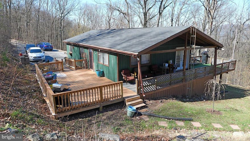 Looking for one level living and privacy and a great kitchen in a commutable location? Found it! Cozy Ranch home on 3 wooded acres with views and big decks.  No need to spend your weekend mowing.  Instead, sit on the shaded side porch and enjoy the wildlife. Neighbors can't see you & you can't see them. Full basement (finish that and you've got over 2000 sq ft). Move in ready.