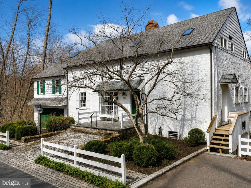 Set within the rolling countryside of Bucks County, this one-of-a-kind converted stone barn offers a lifestyle that feels worlds away from the city—yet is easily accessible from New York, New Jersey, Philadelphia, and the Main Line.

Surrounded by over 10 scenic acres in Buckingham Township’s Spring Valley Historic District, the home blends authentic architectural character with the relaxed luxury today’s buyers are searching for. Soaring ceilings, exposed beams, stone walls, skylights, and walls of glass create interiors filled with warmth, texture, and natural light.

Designed for both everyday living and unforgettable weekends, the home offers expansive gathering spaces, quiet retreats, flexible guest accommodations, and seamless indoor-outdoor flow. The kitchen opens naturally to the sunroom, screened porch, and outdoor entertaining spaces, creating an atmosphere equally suited to intimate evenings or larger gatherings with family and friends.

Outside, winding garden paths, restored stone walls, woodland views, and the gentle sounds of Watson Creek create an unmistakable sense of escape. A covered patio stretching the length of the home, summer kitchen, hot tub, curated gardens, and extensive landscape lighting transform the property into a private retreat throughout the seasons.

Modern comforts include updated systems, whole-house generator, 7-zone heating, heated workshop space, replacement windows and doors, water treatment systems, and comprehensive security monitoring.

Located just minutes from the acclaimed dining, shopping, galleries, and cultural destinations of New Hope and Doylestown, this extraordinary property offers a rare opportunity to experience the character, beauty, and lifestyle that continue to draw buyers to Bucks County from New York, New Jersey, and beyond.