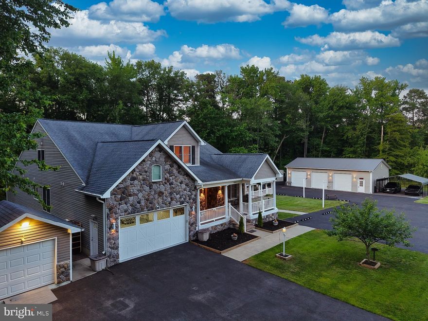 Set on a private, tree-lined 1.8-acre lot with desirable R-5 zoning off Solley Road, this extraordinary custom estate offers over 8,100 square feet of beautifully updated living space designed for luxury, flexibility, and functionality. With 8 spacious bedrooms plus a main-level office that can easily serve as a 9th bedroom, this one-of-a-kind property is perfectly suited for multi-generational living, assisted living potential, a home-based business, or the ultimate setup for car enthusiasts and hobbyists.

A long private driveway with a white picket fence  welcomes you to the home, where a covered breezeway connects to the impressive 1,941-square-foot detached 3-car garage featuring a 9,000-lb vehicle lift, epoxy flooring, kitchenette/bar with sitting area and full bath with shower   a rare and exceptional feature for collectors, mechanics, or workshop needs.

Inside, the thoughtfully designed main level showcases expansive formal living and dining rooms, a warm and inviting family room, and a stunning rear solarium that overlooks Trex decking on the rear deck revealing  peaceful wooded surroundings. The gourmet chef’s kitchen is the heart of the home, featuring 42-inch hardwood-trimmed cabinetry, striking black onyx granite countertops with plenty of bar stool seating,, a large center island with overhead pendant lighting,  double oven , downdraft cooktop, oversized pantry, and abundant prep and entertaining space. A large wood burning  stone fireplace completes the kitchen area. 

The luxurious main-level primary suite offers a private retreat with a spa-inspired ensuite bath complete with dual vanities, soaking tub, oversized tiled shower with bench seating, and a custom walk-in closet with built-in cabinetry and storage solutions. An additional full bath and laundry room complete the main level.
Upstairs, you’ll find two generously sized bedrooms connected by a Jack-and-Jill bath, an expansive recreation room,  an open hallway overlooking the dramatic two-story kitchen and family room below. A convenient built-in laundry chute adds to the home’s thoughtful design.

The fully finished walk-out lower level dramatically expands the home’s possibilities with four additional large legal bedrooms with egress, a second full kitchen with large countertop with plenty of room for bar stools ,formal living and dining areas, recreation room, two full baths, and a large flex space ideal for an office, gym, or additional storage.  A fire suppression system provides added peace of mind, while oversized walk-out stairs equipped with a chair lift offer easy accessibility to the connected covered breezeway.

Additional highlights include an attached 2-car garage, oversized storage shed, and an enormous blacktop parking area with ample space for guests, business vehicles, RVs, or recreational equipment.
Conveniently located near major commuter routes, National Security Agency, Fort Meade, shopping, dining, and Baltimore/Washington International Thurgood Marshall Airport, this exceptional property combines privacy, versatility, and luxury in a truly unmatched setting.