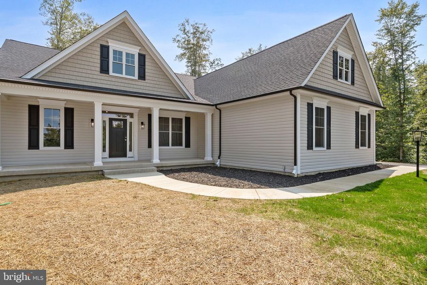 Nestled in the prestigious Keswick community, this newly constructed, true custom built ranch-style rambler by Wilkerson Homes, embodies the essence of luxury living. Completed in 2025, this exquisite home offers a harmonious blend of modern design and timeless elegance, perfect for those seeking a tranquil retreat with high-end features. As you approach the property, the striking exterior showcases a stylish vinyl siding, and oversized porch, setting the tone for the quality that awaits inside. The thoughtfully designed layout features four spacious bedrooms and two and a half bathrooms, ensuring comfort and privacy for all. The open-concept living area is bathed in natural light, accentuated by luxury vinyl plank flooring that flows seamlessly throughout the home. The heart of this residence is undoubtedly the gourmet kitchen, equipped with top-of-the-line appliances and ample quartz counter space, making it a dream for culinary enthusiasts. The adjoining dining area is perfect for hosting intimate gatherings or enjoying quiet meals with loved ones. Step outside to discover the expansive 1.23-acre lot, offering endless possibilities for outdoor enjoyment. Whether you envision a lush garden, a serene patio for morning coffee, or a space for entertaining under the stars, this property provides the canvas for your dreams. The walkout basement, complete with rough-in plumbing and windows, presents an opportunity for additional living space tailored to your lifestyle. Parking is a breeze with a side-entry attached garage accommodating three vehicles, complemented by a generous driveway that can accommodate six additional cars. This thoughtful design ensures convenience for both residents and guests. The home's excellent condition reflects meticulous craftsmanship and attention to detail, making it move-in ready for those who appreciate the finer things in life. You can spend your time enjoying the peaceful surroundings and the exclusive lifestyle that Keswick offers. Welcome to your Wilkerson Home! 🏡 💕