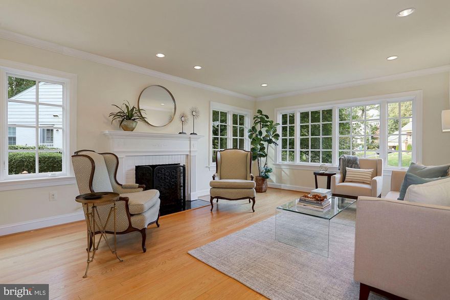 New Price on this fabulous house, perfect for the 2021 New Normal. Located in the coveted Country Club Hills, this house was thoughtfully designed and renovated to work and attend class from home, cook and gather for family meals, run around  in the .35 acre yard, ride bikes, scooters and play ball in the double cul de sac. In addition, it is a short distance to Gulf Branch Nature Center,  an abundance of green space and lovely trails to and along the Potomac River.  All this and just 4 miles to DC.  The yard is beautifully landscaped with two stone patios to social distance and a front porch that is perfect for sipping coffee in the morning and your favorite beverage in the evening. The interior boasts lots of natural light, an open floor-plan and a grand,  welcoming foyer featuring detained woodwork and a  style defining staircase.  The gourmet kitchen features an eight burner gas range with two standard ovens, a subzero refrigerator, an ice maker, two dishwashers, two sinks and a stunning island. The large dining area opens, through French doors, to a slate patio perfect for grilling and entertaining. The warm and cozy family room with a gas fireplace opens, through French doors, to a large patio that overlooks a spacious backyard. The main level also features a light-filled living room with a gas fireplace and a MASTER/IN-LAW/NANNY SUITE WITH A BEDROOM WITH FRENCH DOORS OPENING TO A BEAUTIFUL STONE PATIO, SITTING ROOM, FULL BATH, WET BAR AND ITS OWN WASHER AND DRYER.   The second level features a large Master Bedroom ensuite with walk-in his and her closets, a large office or bedroom, two additional bedrooms and a hall bath.  The third level features a bedroom, two offices/playrooms/possible bedrooms and full bathroom. The lower level has a family room with a gas fireplace, a full bathroom, extra storage and a two car garage with lots of  room for bikes, scooters, kayaks and more.