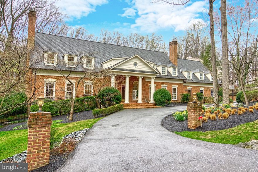 Welcome to your forever home! This stately Georgian colonial features elegant curb appeal with its circular drive and manicured landscaping. A side-loading, 3 car garage and parking area provide ample space for large gatherings. As evening falls, twilight lighting gives this home a truly magical appearance. Built in a manner seldom seen in new construction, upon entering the grand two story foyer, you begin to take in the gracious scale and design features of this home. The rooms were planned to accommodate both grand receptions and intimate family gatherings. Rich, hardwood flooring runs seamlessly throughout the main and upper levels. Exquisite moldings, 6 interior fireplaces (4 have been converted to gas), tall ceilings and beautiful windows give one the feeling of timelessness. The formal living room and dining room flank the entrance foyer. The large and welcoming family room with its paneled ceiling and soaring windows adjoins the kitchen which has been updated to make any chef’s heart sing. This is a huge working space, the hightlights of which include a double island, a 6 burner gas range with double ovens, a hammered metal prep sink and a separate ice maker and beverage refrigerator. The breakfast area of the kitchen leads to an outdoor deck with travertine tile which overlooks the resort-styled rear yard. Completing the main floor is a private, paneled office with its own fireplace and balcony, multiple powder rooms, laundry and mudroom as well as a rear staircase. On the second level, one entire wing is devoted to the primary suite. This space has a stunning new bathroom, gas fireplace, sitting area and a charming balcony overlooking the rear yard. The four secondary bedrooms in the adjoining wing are all beautifully sized, 3 with updated en suite bathrooms and all have walk-in closets. The final upper level is a massive, skylit space with another full bathroom. The home’s lower level is a fully finished walk out space with four distinct entertaining areas, a two-sided gas fireplace, and a  built-in bar. There is another bedroom and full bath on this floor as well as generous storage spaces. Multiple sets of doors lead to the back yard designed by Fine Landscapes.   The owners have created a spectacular space outside. This home is situated on a very private lot, just under 2 acres, and backs to the tree-lined conservation area of the Madeira School. Stone patios create multiple entertaining options and areas. Gather around the stone, gas fireplace or take a dip in the magnificent, heated pool. The waterfall spa gives one a perfect view of the fantastic covered pavilion area with its stunning stone, wood burning fireplace, perfect for watching games on the television. A stacked stone bar creates an excellent party hub. At dusk, the surrounding landscape, pool and waterfall are beautifully lit. If you didn’t know better, you might think you were in Aspen! This home, on this property, gives you what a new build cannot. The owners have meticulously maintained their home updating all important infrastructure items. With its 6 bedrooms, huge loft suite and 6 full and 2 half bathrooms, this home can easily accommodate an au pair or in-law suite. Located in a strong school pyramid and convenient to world class shopping, dining and commuter options, this is absolutely a dream home! The pool’s open; what are you waiting for?