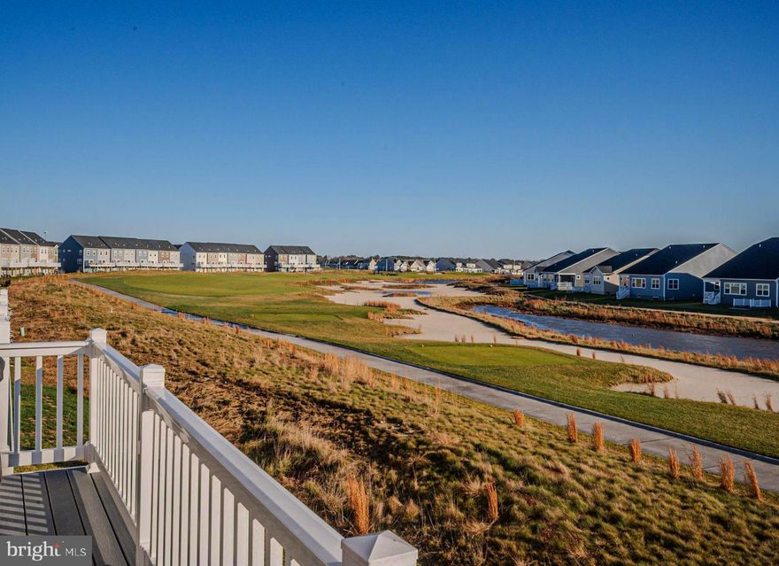 Experience elevated golf-course living in this nearly new luxury town home, perfectly positioned amid the lush, rolling greens of the well-maintained Plantation Lakes Golf & Country Club—home to the renowned Arthur Hills Championship golf course. Lightly used as a vacation retreat and meticulously maintained, this move-in-ready home offers open-concept living paired with spectacular fairway views.

Step into the bright, welcoming foyer and ascend to an open-concept living space where modern design meets natural beauty. The thoughtfully designed kitchen takes center stage with sleek cabinetry, stainless-steel appliances, and an oversized statement island—perfect for entertaining. The space flows effortlessly onto a durable composite deck overlooking the golf course, offering a front-row seat to serene fairway views. Spend your evenings sipping wine or cocktails while soaking in the scenery, whether basking in the sun or relaxing in full shade beneath the remote-controlled, fully retractable awning. 

The upper level features a spacious primary suite with a spa-inspired en suite bath, double vanities, a walk-in shower with built-in bench, and a large walk-in closet. Two additional bedrooms offer flexible space for guests, a home office, or hobbies. A conveniently located second-floor laundry room enhances everyday functionality.

The lower-level bonus room provides exceptional versatility and can be used as a recreation area, fitness room, or in-law suite. Complete with a powder room and oversized glass sliding doors, this space opens to sweeping views of the fairway—ideal for enjoying your morning coffee or evening cocktail.

Additional highlights include an integrated Ring security system with thermostat, smoke, and carbon monoxide monitoring, all controlled through a mobile app.

With breathtaking sunset views and world-class amenities just steps away, this town home delivers the ultimate golf course lifestyle. Plantation Lakes offers an exceptional resort-style experience, including an award-winning 18-hole championship golf course, Clubhouse with Bar and Grille, pools, tennis and pickle ball courts, fitness centers, scenic walking paths, and playgrounds. The community is pet-friendly and boasts multiple clubhouses with cardio and weight-training facilities.

At the heart of the community, the Landing Clubhouse serves as a vibrant social hub featuring a Bar & Grille, ballroom, fire pit patio, multi-sport simulator, and flexible event spaces. Ideally located near top-rated schools, everyday conveniences, and just 17–22 miles from Lewes, Rehoboth, and Bethany beaches, Plantation Lakes is more than a neighborhood—it’s a lifestyle where luxury meets coastal charm.