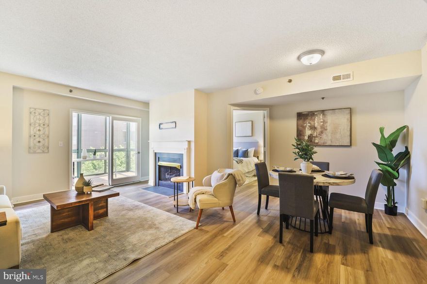 Welcome to this beautifully updated home in the sought-after Windsor Plaza, offering a spacious layout with two sunrooms and over 1,200 square feet of stylish, comfortable living. Recently renovated, this unit features brand new luxury vinyl plank flooring and fresh Sherwin Williams “Drift of Mist” paint throughout, creating a light and airy feel.

The kitchen is both functional and inviting, with granite countertops, white cabinetry, stainless steel appliances, gas cooking, and a breakfast bar that opens to the main living area. A dedicated dining space flows seamlessly into the family room, anchored by a gas fireplace. Glass doors lead to the first of two sunrooms, overlooking quiet, tree-lined Taylor Street in the heart of Ballston.

The spacious owner’s suite includes a large walk-in closet, a private sunroom perfect for a home office or reading nook, and a renovated en-suite bath featuring a soaking tub/shower combo and a dual-sink vanity with brand new quartz countertops, sinks, and fixtures.

The second bedroom, situated on the opposite side of the condo for added privacy, offers two closets and access to a dual-entry bath with a glass-enclosed shower. A premium, garage parking space is also included.
Windsor Plaza is a vibrant community of two buildings centered around a lush courtyard with a pool and grilling area—ideal for relaxing or entertaining. Located just one block from Ballston Metro and three blocks from Ballston Quarter, this condo offers an unbeatable urban lifestyle in a serene setting.