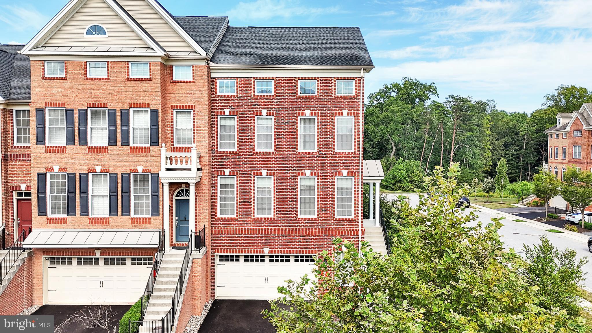Welcome to 8537 Pine Springs, a Toll Brothers masterpiece nestled in the prestigious community of Arundel Forest. This exquisite four level end-of-group residence boasts a stately brick exterior with a charming side entry, covered portico, lush greenery, and an elegant two-car garage. Step inside to a sun-filled foyer adorned with gleaming hardwood floors, crown molding, and sophisticated formal living and dining rooms enhanced by chair rail detailing and a sparkling chandelier. The gourmet kitchen is a chef’s dream, showcasing a five-burner gas cooktop with exterior-vented hood, wall oven, built-in microwave, stainless steel refrigerator, and an abundance of counter space. Stunning 42" custom Snow White cabinetry with contrasting black hardware is complemented by a timeless white subway tile backsplash. A butler’s pantry seamlessly connects the kitchen to the dining room, while the adjacent breakfast nook opens to a beautiful TRX deck, perfect for morning coffee or evening gatherings. The inviting family room offers expansive windows, hardwood flooring, and a ceiling fan, creating a warm space for relaxation. A stylish powder room completes the main level. Upstairs, the luxurious owner’s suite features a private sitting area, custom walk-in closet, and spa-inspired bath with a soaking tub, frameless glass shower, dual granite vanities, and a private water closet. Two additional spacious bedrooms share a full bath with ceramic tile, while a convenient laundry room enhances functionality. The upper fourth level offers brand-new carpet, vaulted ceilings, skylights, and a half bath—ideal for a home office, lounge, or guest retreat. The walk-out lower level presents a remarkable in-law suite with its own full bath, a custom wet bar with cabinetry, stainless steel sink, and mini refrigerator—perfect for extended family or overnight guests. This home is thoughtfully constructed with energy-efficient features for comfort and savings. Located in the amenity-rich Arundel Forest community, residents enjoy access to a clubhouse, pool, fitness center, playgrounds, and scenic walking trails. Conveniently positioned near major highways, BWI Airport, shopping, dining, and entertainment, this home offers both elegance and accessibility.