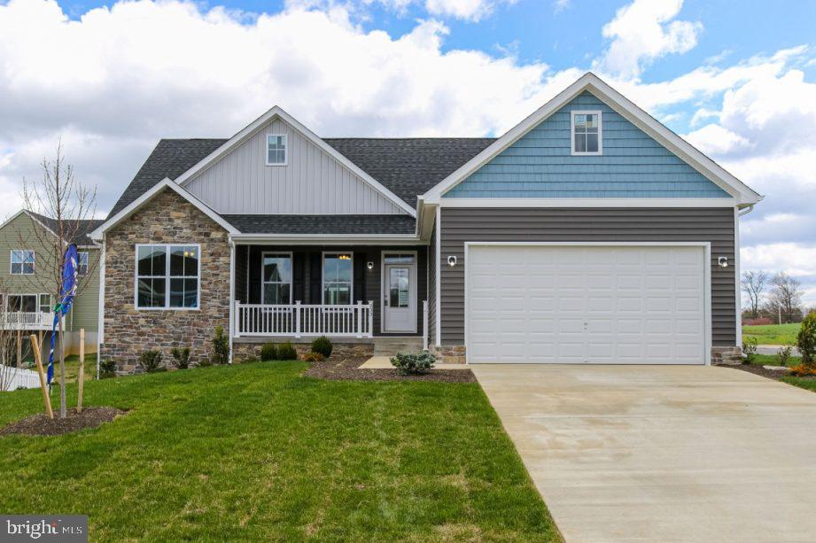 One of our most popular floor plans is now available on a prime corner lot in Nadenbousch Pines!
Enjoy the ease of one-level living with vaulted ceilings, large windows, and a sunroom that fills the space with natural light. There's still time to choose your interior finishes and exterior colors — move-in ready in December!
This home is designed for comfort and convenience, featuring quartz countertops, soft-close cabinetry, luxury vinyl plank flooring, high ceilings, and a tiled shower in the primary suite. Outside, there is an inviting front porch and rear patio.
Nadenbousch Pines offers a peaceful setting with quick access to Inwood, Charles Town, Martinsburg, and I-81 — perfect for commuters or those seeking space with convenience.
Seller incentives include 3% toward buyer closing costs, a builder warranty, HVAC warranty, and a 10-year structural warranty. December delivery.