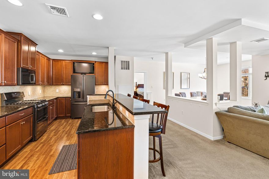 This is one of the more spacious units available in Huntingdon Place, featuring 2 bedrooms, a den/office, and 2 bathrooms. The open floor plan provides a grand feel, while maintaining a cohesive flow, and distinct areas for specific activities. The home benefits from an abundance of natural light, thanks to numerous windows throughout. The kitchen is equipped with granite countertops, gas cooking, cherry cabinetry, and a breakfast bar that seamlessly connects to the living and dining rooms. The in-unit laundry adds convenience.  This unit is just steps from the elevator offering direct access to the covered garage, where one parking spot is reserved, with the option to rent additional spaces if needed.  Huntingdon Place is a luxury condominium community featuring in-house amenities. Located just minutes from the Bethayers train station, shopping, restaurants, numerous salons and easy access to the Pennypack Trail.  It's where comfort, convenience, and natural beauty come  together!