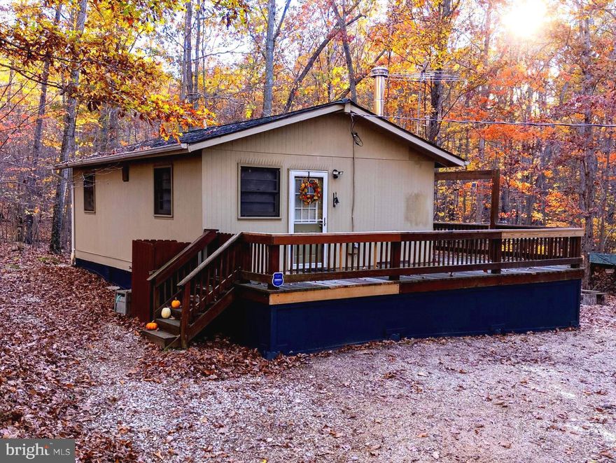 Welcome to 335 Wildwood Lane – a fully furnished mountain retreat in the premier Shenandoah Gap cabin community. This charming two-bedroom, one-bath cabin sits on 1.72 acres across two lots, offering the perfect blend of comfort, privacy, and natural beauty. Ideal as a full-time residence, weekend escape, or short-term vacation rental, this property provides a true Shenandoah Valley experience. Inside, you will find an inviting open-concept living area centered around a cozy wood-burning fireplace and a propane wall heater for year-round comfort. The cabin’s thoughtful layout makes relaxing or entertaining effortless. Outside you will enjoy the spacious deck with Blue Ridge Mountain views, perfect for sipping your morning coffee or spending starlit evenings by the nearby firepit. Recent updates include new exterior finishes and upgrades, along with a new mini-split system for efficient climate control inside the cabin. Two storage sheds provide ample space for outdoor gear, tools, or hobbies. Enjoy access to the HOA’s recreation lot on the Shenandoah River—ideal for fishing, canoeing, or picnicking—and the nearby 400+ acre nature preserve bordering Shenandoah National Park, for endless hiking and exploring. The HOA maintains the access road and provides snow removal, offering year-round peace of mind. The additional included lot allows for the potential construction of another dwelling or cabin. With nearby successful short-term rentals and a turn-key setup, this property combines relaxation, recreation, and investment opportunity in one exceptional mountain getaway.