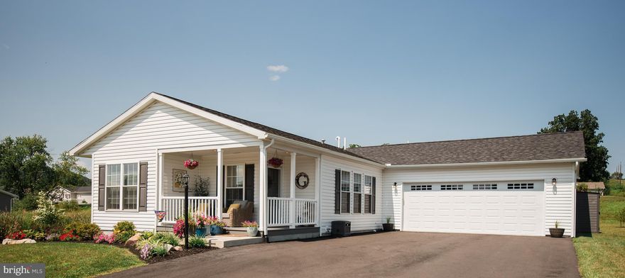 Wow! That’s the first thought when you step into this home. Built in 2022, this expanded Lexington model in the desirable 55+ community of Spring Valley Village is everything you're looking for! Situated on one of the largest lots in the development, there is plenty of space and privacy. The oversized driveway fits up to 6 cars, and the expanded 2-car garage provides ample room for parking, storage, and workspace. The wrap around covered porch is a perfect spot to relax. Inside, the open floorplan features a GREAT room that combines the kitchen, living room, and dining room. The spacious 9' island seats 4 comfortably, and the modern kitchen boasts 36" high overhead cabinets, a desk area, tile backsplash, stainless steel appliances, and recessed lighting. Adjacent to the kitchen is a versatile den, ideal as an office or guest room, while the laundry room across the hall includes a custom built-in counter with cabinets making folding laundry a breeze. Down the hall, there’s a second bedroom and full bath, and at the back of the house, the master bedroom features a huge walk-in closet and an ensuite bath with vanity, stall shower and linen closet. The large rear patio, located behind the garage, is perfect for grilling and entertaining. Spring Valley Village offers an active lifestyle with amenities like a clubhouse, library, fitness center, and walking trails. Conveniently located near Routes 100, 73, and 422, it’s close to shopping and medical facilities. Don’t miss out—schedule a visit today!