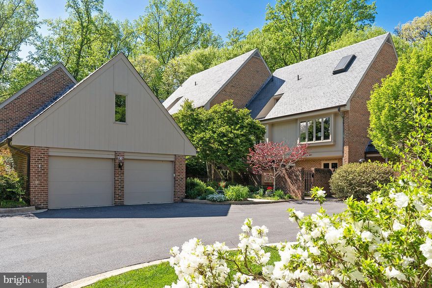 Rare Opportunity and Fabulous New Price in Exclusive Merrywood on the Potomac.
Tucked within an intimate enclave of just eight homes, this elegant townhome offers luxurious living just minutes from downtown Washington, D.C. A private courtyard leads to the main entrance and a gracious foyer, setting the stage for the refined interiors beyond.

A dramatic living room features soaring ceilings, a central fireplace, and tranquil views of the rear garden and protected natural landscape bordering the historic Merrywood estate. The formal dining room easily accommodates 12–14 guests, while the adjacent kitchen offers a breakfast area with direct access to the front courtyard.

The upper level features a spacious primary suite with sweeping views, a fireplace, multiple closets, and a walk-in dressing room. The fully renovated primary bath showcases high-end finishes and timeless design. Two additional bedrooms with en-suite baths complete this level, while the top floor offers a private suite with vaulted ceilings, built-in bookshelves, and a full bath.

The walk-out lower level includes a generous recreation room opening to a stone terrace and garden, climate-controlled wine storage for 240 bottles, a fifth bedroom, full bath, laundry room, and a utility/storage room with exterior access. The home is elevator-ready with vertical space allocated for future installation.

A detached two-car garage includes a spacious 600 SF loft with a window—ideal for a home office, art studio, or fitness room.

Offering rare scale, privacy, and proximity to the Nation’s Capital, this distinguished residence combines rich heritage with turnkey elegance in one of McLean’s most coveted communities.