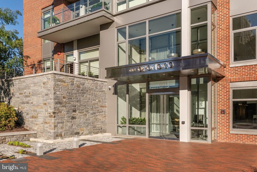 Rare rental opportunity in The Oronoco, a premier condominium in Old Town Alexandria overlooking Oronoco Bay Park and an easy stroll to historic King Street and all of the shops and restaurants that Old Town has to offer. Upon entering the elegant two-story Lobby you will experience the amenities that this luxury building offers,  including a 24 hour concierge desk to greet your guests. Just off of the Lobby is a fitness center with yoga room, a children's playroom and a meeting room.  Additional amenities include an outdoor heated pool with a sun shelf and  outdoor bathhouse and kitchen,  bike storage, and an electric car charging station.   As you enter through the foyer to this lovely home you encounter a 34' x 27' great room which encompasses your living/dining area and a gourmet kitchen designed for entertaining.  This expansive floor plan  offers 10' ceilings and 5" hardwood plank flooring and recessed lighting throughout. The floor to ceiling walls of tinted glass overlook the balcony and landscaped courtyard below. The automated solar shades  offer privacy when desired and the balcony door has a roller screen for enjoying  fresh air.  The 17' balcony also has a gas grill installed for your use.    The Living area features a very sleek, contemporary gas fireplace and a built-in wet bar with a 48-bottle wine cooler. The upgraded kitchen features Crystal cabinetry, Cambria countertops and custom travertine backsplash.  A Sub-zero bottom freezer refrigerator and Bosch dishwasher are hidden behind custom cabinetry and the 5 burner gas cooktop, convection oven and microwave are all by Wolf.  The primary bedroom suite offers an expansive bath with a large dual sink vanity with Crystal cabinetry, custom mirrors and lighting and a large frameless glass walk-in shower of travertine.  Two separate walk-in closets each boast custom cabinetry. The secondary bedroom also offers an ensuite bath with a tub/shower combo and a customized closet.  In addition there is also a separate Laundry room with customized cabinetry which includes a convenient fold-out ironing board and a powder room off of the foyer.  This unit includes two very roomy parking spaces (#149 & #150 on P1) and an unusually large (11' x 9') private storage room for your use. Available now for a minimum one year lease.Sorry,  no pets, no smoking.