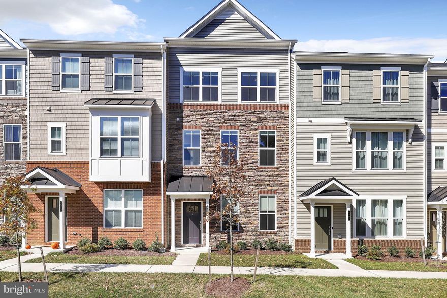 More upgraded than the model! Welcome to this 1 year young new construction townhome, perfectly situated in the highly sought-after Long Gate Overlook! With 4 spacious bedrooms, 3 full baths plus 2 half baths, and 3-zone AC, this home is designed for modern living. As you enter on the ground level, you’re greeted by a versatile bedroom with an en-suite full bathroom, providing easy access to the attached 2-car garage. The second story is a showstopper, featuring a bright living room with a stylish half bath and a gorgeous kitchen that’s a chef's dream! Enjoy cooking with stainless steel appliances, a gas range, double oven, and a large island, all complemented by a beautiful tile backsplash. The open dining area flows seamlessly to a lovely balcony—ideal for relaxing or entertaining al fresco. The third floor is dedicated to comfort, showcasing the primary suite complete with a luxurious full bathroom featuring dual vanity and a standing shower. You'll also find a laundry closet with a stackable washer and dryer, a full guest bathroom, and two additional guest bedrooms. Head up to the fourth story, where you’ll discover a versatile family room with a half bath, leading to your very own rooftop balcony—a perfect spot to unwind and enjoy stunning views! This energy-efficient new construction home was designed to outshine the model home - please ask for a full list of upgrades. Don’t miss your chance to call this remarkable property home! With tennis and basketball courts, nearby amenities, and a vibrant community in desirable Ellicott City, schedule your tour today!