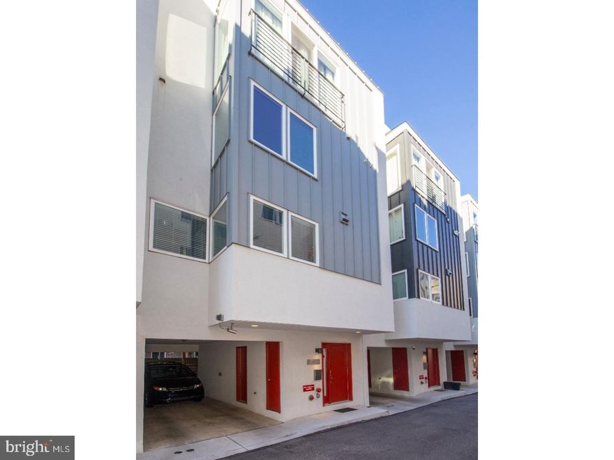 Located in Passyunk Square, walking distance to shopping, restaurants, transportation and all of center city... The opportunity to own this incredible 4 bedroom, 2.5 bath home with amazing roofdeck with center city views, finished basement and 2 CAR PARKING is here!! The covered carport fits 2 cars, has a storage closet and trash area. Enter into the large foyer with half bath. Lead down to the finished basement and large storage area. Second main floor features a wide open floor plan, kitchen compete with stainless appliances, granite counters, plenty of pantry and cabinets. Spacious deck off of the living area makes grilling and outside dining convenient. Third level has two large bedrooms both with spacious closets, a large bathroom with dual sinks with granite counters and a full sized laundry room. The next level features another bedroom and the spacious, sunny, master bedroom with walk-in closet and master bath with glass shower, dual sinks and granite counters. Up the steps once again to the amazing roofdeck;  great for entertaining!  Do not forget... this home has approximately 6 years left on the tax abatement!