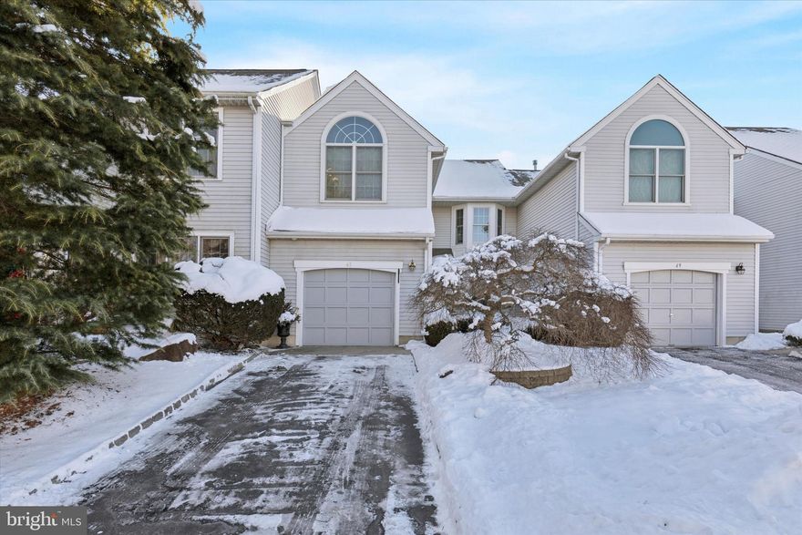 Welcome to Gwyn Ayre, a beautifully maintained townhome community nestled in desirable Lower Gwynedd Township. Step into the welcoming foyer, where gleaming hardwood floors flow seamlessly through the living room, dining room, and family room, creating a bright and inviting atmosphere. Fresh, sophisticated paint colors and an open-concept layout enhance the home’s timeless appeal. To the right, the step down living room features a large bay window, and elegant crown molding that enhances the room’s appeal. A step up leads you into the formal dining room, where chair and crown molding and double windows offer picturesque views of the open space behind your home. The kitchen is a true chef’s dream, offering updated cabinetry, complemented by granite countertops, a stylish tile backsplash, and high-end GE Profile stainless steel appliances. There is even a separate area that makes a nice coffee bar space. Adjacent to the kitchen, the cozy den with a gas fireplace and vaulted ceiling leads to your private paver patio—an ideal space for hosting guests or enjoying a peaceful retreat. A beautifully remodeled powder room ,with a large custom vanity, along with convenient access to your attached garage, completes the first floor. Upstairs, plush carpeting and neutral tones continue the home’s polished feel. The hallway leads to a completely remodeled hall bath with a walk-in tile shower, custom vanity, a sought-after second-floor laundry room, and a spacious linen closet. The  primary suite is a true sanctuary with its front bay window, large ensuite bathroom with dual vanities, walk-in shower and soaking tub as well as a walk-in closet with custom shelving ensuring you have plenty of room to keep things organized. The second bedroom features a large closet and a front-facing window with serene views of the community. Looking for more space? The finished basement is a must-see, featuring plush carpeting, fresh paint, wainscoting and a large bedroom with a walk- in closet, an entertainment space and another room that can be used as an office, gym or additional bedroom. There is also an additional storage room to help you keep everything neatly organized.  Newer Pella windows throughout and HVAC system(recently serviced) add to the amenities of this home.  Gwyn Ayre is ideally located in the Wissahickon school district within walking distance to the Whole Foods Shopping Center and the scenic township trails. With easy access to SEPTA trains, Route 309, the PA Turnpike, downtown Ambler, and the Ambler YMCA, this home offers the perfect blend of convenience and comfort.