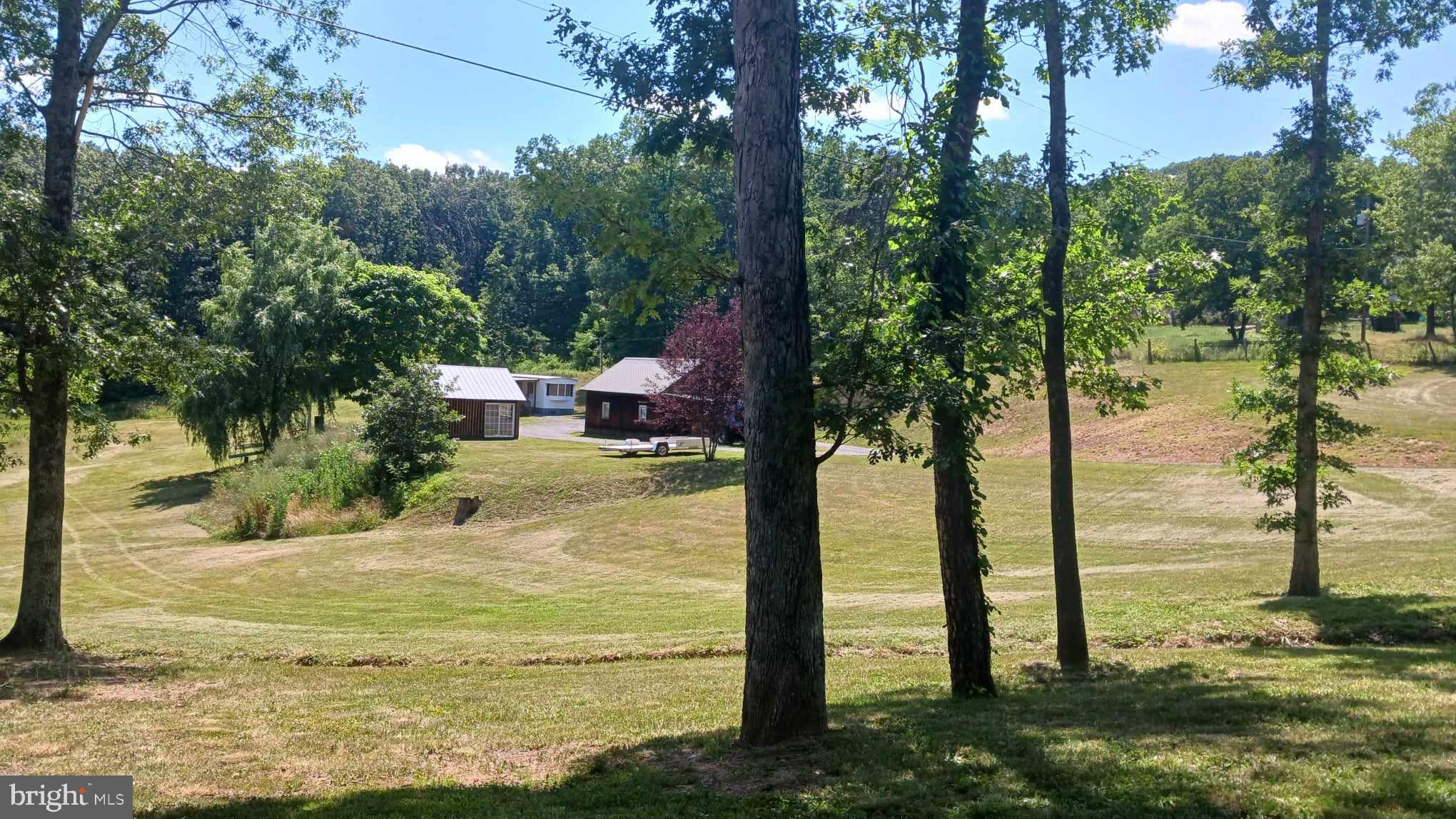 Charming 2-bed 1-bath home on beautiful rolling 2.5-acre unrestricted lot in picturesque Augusta, WV. Barn, oversized garage, and shed offer tremendous farmette potential! Perfect for off-grid living, weekend getaway, or AirBnb! Level and gentle sloping areas. Enjoy river recreation on nearby Cacapon River. Thirty minutes to Winchester and Capon Bridge. Under an hour to Historic Berkeley Springs and Cumberland MD. Just over 2 hours to DC! Sign on property. Must be accompanied by agent. Must have appointment to tour. Buyers Agents: Please submit ALL provided forms with offer. Must include picture of EMD/Proof of Funds, full listing printout, and copy of tax record with offer. Sold strictly as-is. Sign on property. This one won't last!