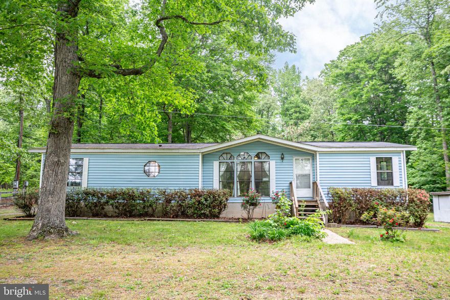 One level living on 1.5 acre lot! This three bedroom two bath home boasts almost 1,600 fin. sqft with large family room and gas fireplace. Split bedroom design with primary bedroom & bath. Rear deck overlooking rear yard backing to trees. Multiple sheds with power great for workshop and storage. Open cleared lot with plenty of room for that boat or RV! All this and close-in location just mins. from shopping & commuter lot!