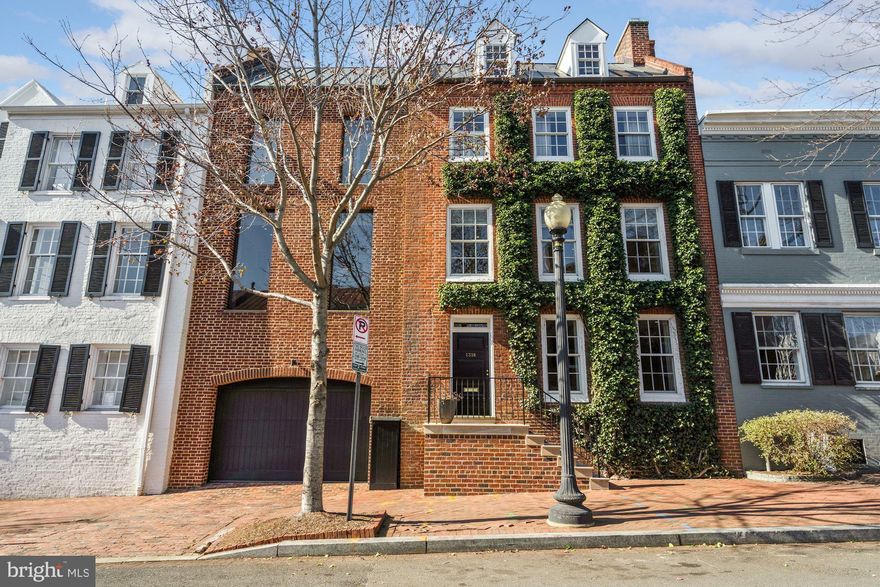 Perfectly located in Georgetown’s East Village this lovely and unique residence presents a stunning combination of the historic and the modern with an original 1810 Federal period home complemented by a large side addition done by noted Georgetown architect, Hugh Newell Jacobsen constructed in the 1970’s. Under the supervision of the current owners and with the assistance of architect, Dale Overmyer, the home underwent a comprehensive 2- year renovation, restoration and expansion completed in 2009. The home features wonderful details, such as, original hardwood floors, stair railings, along with period stone and brick restored to perfection.  The main living spaces feature an elegant formal living room with original pine floors, wood-burning fireplace and an original pine mantel.  A cozy and  charming formal dining room also with original wood floors,  wood -burning fireplace and mantel includes  floor-to-ceiling windows and a door providing access to the patio. A spectacular large open gourmet kitchen /family room featuring 9'6" ceilings  and  a dramatic wall of floor-to-ceiling French doors and windows leadS out to a gorgeous, large flat rear garden designed by Oehme Van Sweden. A generous patio space flows seamlessly toward  a stunning 36' x 9'6" swimming pool with fountain all sheathed in Jerusalem limestone.  A very private primary suite includes a luxurious Waterworks/Ann Sacks marble bathroom, a large custom walk-in-closet and a rich wood paneled bedroom overlooking the rear garden and pool from a wall of floor-to-ceiling windows .The home includes 4 additional bedrooms and three additional full baths and two half baths along with a bright and airy family room located on the top floor of the home.  A large attached 1-car garage provides convenience and privacy. This home with its thoughtful design and amenities has been done to perfection with no detail overlooked. Its care and maintenance is meticulous with recent updates including the replacement of all 4-zone HVAC systems in 2018.