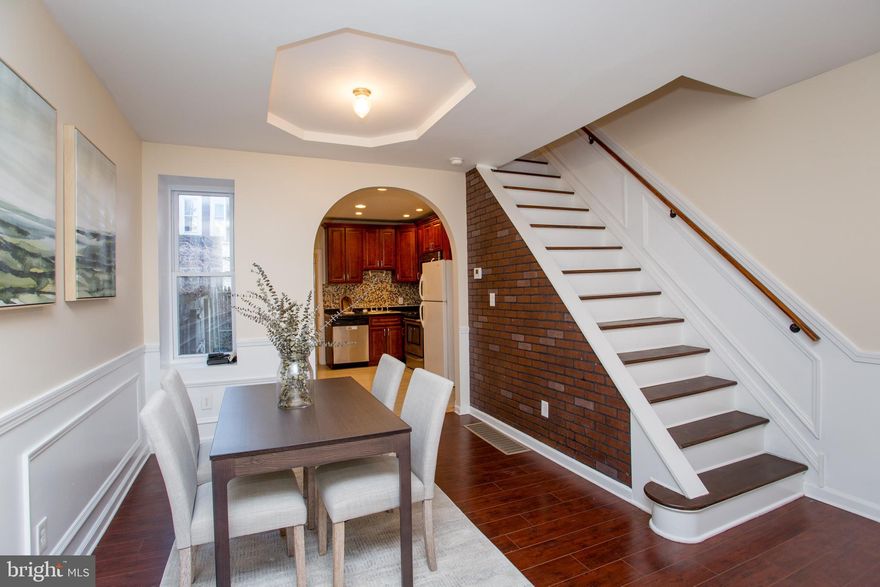 Welcome to 5230   Hazel Avenue, located in the Cobbs Creek neighborhood, adjacent to Cedar Park and just minutes away from University City. This beautiful row home features three bedrooms and one and a half bathrooms, offering comfortable and convenient living. As you enter, you'll find a welcoming living room with beautiful wooden floors and a cozy atmosphere. The open-concept living and dining areas seamlessly connect to the kitchen, which is equipped with stainless steel appliances .
Recessed lighting enhances the space, creating a bright and inviting environment. On the main floor, there is also a convenient half bathroom and access to the backyard through a rear exit door. Upstairs, you'll discover three generously sized bedrooms and a full bathroom, providing ample space for family or guests. The finished basement features a laundry area, a central air unit, and an additional room that can serve as a home office, gym, or extra storage. This home boasts a small backyard perfect for relaxing outdoors, as well as a front porch to enjoy neighborhood views. Move-in ready and well-maintained, this property is waiting for its new owner. This home has distinctive features that wil wow you and upgrades to delight you with an upgraded kitchen, newly painted first floor and a fabulous, finished basement. Easy access to University City, restaurants as well as major thoroughfare's. Welcome to the neighborhood!