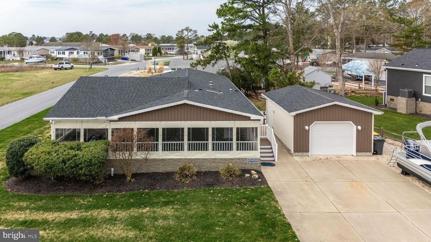 Welcome to 34854 Clew St #53190, Millsboro, DE 19966 in Pot Nets Bayside.  This corner lot faces the marshland with unlimited wildlife to watch.  This 1800 square foot home has been completed updated and is very beachy inside. The ship lap wall is amazing in the family room, along with 3 nice size bedrooms and 2 full bathrooms.  The garage is oversized and is great for storage or an extra hangout.  The oversize driveway is great for boat parking.  The best part of the home is the oversized wrap around porch with Eisenhour glass for winter usage also.  Hurray this one with not last.  Close to Paradise grill by golf cart, and boat ramps and slips.
