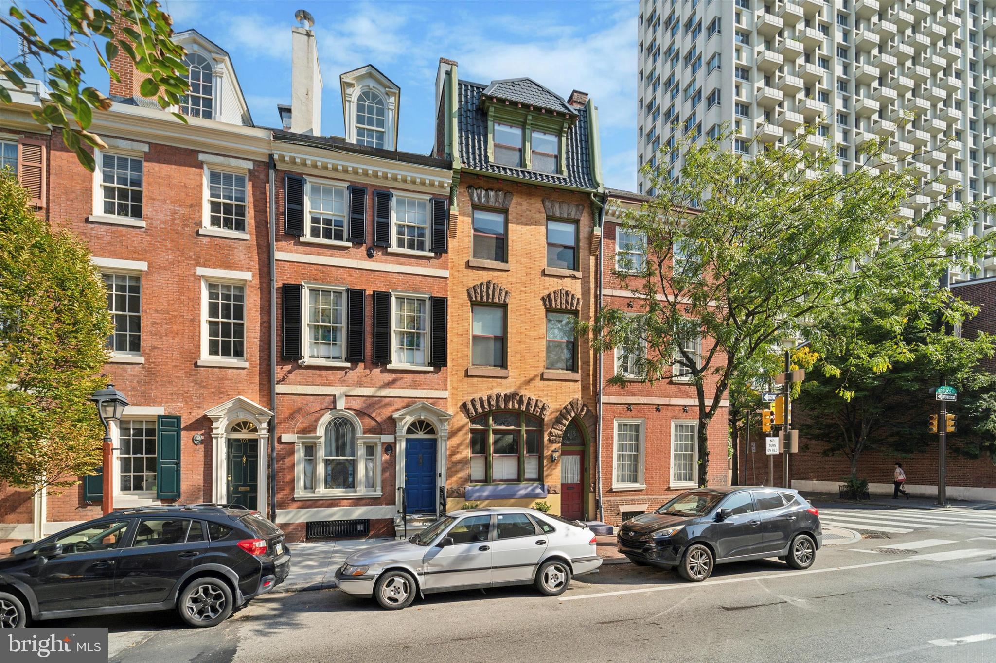 OPEN HOUSE IS CANCELED. Welcome to 703 Spruce Street, a stunning 3 ½-story Victorian Romanesque gem that seamlessly blends historic charm with sophisticated updates. Built circa 1809 by Joseph L. Williams, this exquisite residence showcases an eye-catching pyrated orange Pompeiian brick façade with intricate details that highlight its architectural heritage.
The home features a distinctive rusticated brownstone watertable and a captivating Gothic arched doorway adorned with brownstone voussoirs and a beautiful stained glass transom.
Step inside to find an inviting, spacious interior with exquisite period details and modern updates. The main level offers a grand living space with high ceilings, elegant woodwork, and a harmonious flow between rooms. The updated kitchen is a chef’s delight, complete with top-of-the-line appliances, ample cabinetry, and a charming breakfast nook. Retreat to the generously-sized bedrooms, including a luxurious primary suite with a private bath and walk-in closet. Each of the additional bedrooms is thoughtfully designed to provide comfort and privacy. The home also features 3.5 well-appointed bathrooms, all designed with a blend of classic and contemporary finishes.
Significant alterations were made around 1892 by Beck and Comley, including a new façade and mansard roof, ensuring that this historical treasure remains a standout in contemporary times.
This remarkable property offers a unique opportunity to own a piece of architectural history, blending Victorian Romanesque elegance with modern enhancements. Don't miss the chance to make 703 Spruce Street your own.