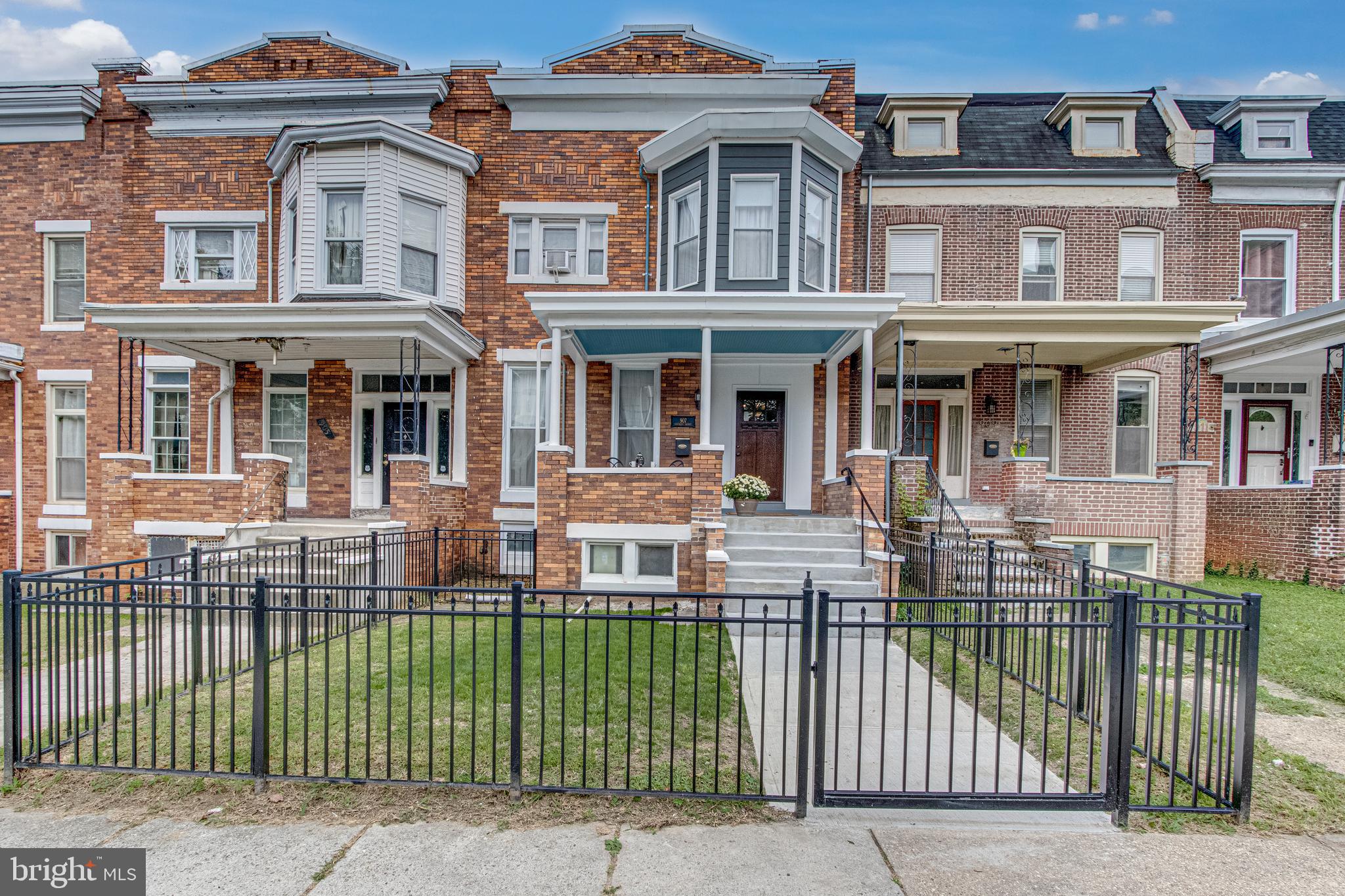 Pristine brick and stone porch front row home, impeccably maintained in Baltimore just steps from Druid Park in Reservoir Hill! Pride of ownership is instantly apparent from this home's stunning curb appeal. 13 solar panels are owned and provide energy efficiency! Enter gate of newly added fence to clean sidewalk and stairs to the grand porch front, great for relaxing out doors. The exquisite door opens to a grand foyer entry way accented by shadowboxing and gleaming high end laminate wood flooring. The large living room sits to the left of the foyer, situated in the front of the home, and features crown molding, chair rail, recessed lighting, 2 large windows, and faux fireplace with mantle serving as the focal point. The living room opens to a beautiful dining room situated in the rear of home featuring crown molding, chair rail, and 2 large windows. Dining room is open to large gourmet kitchen boasting gorgeous cabinets topped with granite counters and accented by a tile back splash. Stainless steel appliances including gas stove gleam in the large, open kitchen with crown molding and recessed light. Rear door exits to beautiful deck that includes stairs to the fully fenced grassy yard. Take the beautiful staircase to the upper level that features all new carpet. The large primary bedroom sits in the front of the home and includes a ceiling fan, double door closet, and 3 window bay bump out with sitting area. Full primary bath includes new vanity and medicine cabinet, luxurious whirlpool soaking tub with exquisite tile surround, and separate shower. 2 additional bedrooms are situated in the rear of the home, each with ceiling fans, large closets and nice windows. The large basement is fully finished and provides a family room for additional entertaining and relaxing space. Recessed light and new carpet throughout. Large 4th bedroom on this level with window and closet and full bath with new vanity and medicine cabinet and shower with beautiful tile work. A great space for guests! Laundry room with tiled floor and exit to rear yard. New insulation added to the front, back, and roof. French drain exists. Energy efficient solar panels are owned! Plenty of street parking and ability to park in the back yard! Walk to beautiful Druid Park or bike around the lake! Enjoy close proximity to countless restaurants and shopping in Baltimore. You must see this beauty for yourself! Schedule your tour today!!