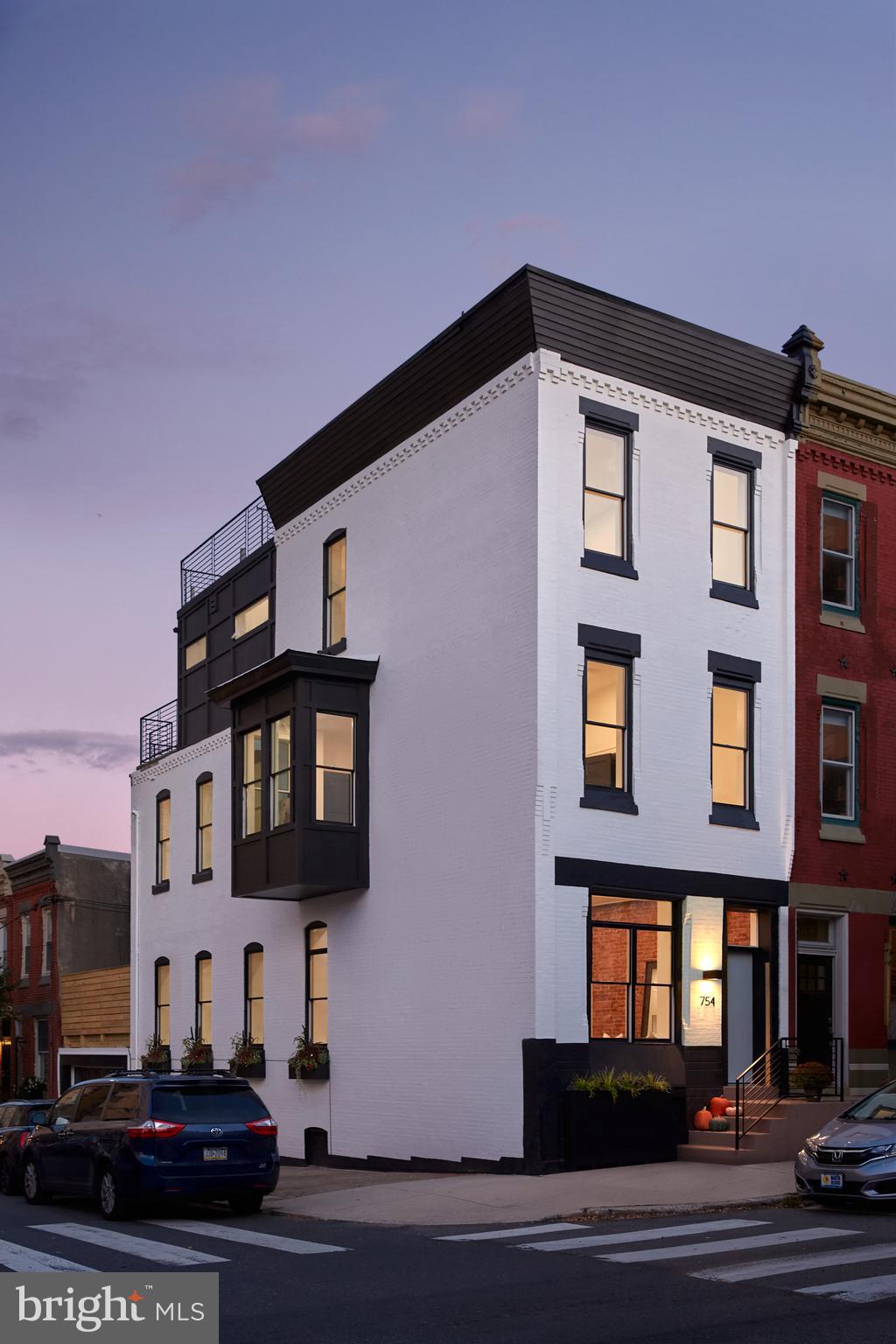 Introducing Seven Five Four, a bespoke new build tailored to the finest level of detail, optimally located just above the iconic Philadelphia Museum of Art, with museum views from every floor. As an homage to the property’s heritage, the Property comes with a full membership to the Philadelphia Museum of Art, as it was once home to a local art collector. This 4bd x 3ba 3100 SF Pennsylvania residence is equipped with a gourmet kitchen featuring timelessly modern two-toned maple and oak cabinetry; 2-car garage; 3 outdoor terraces totaling an additional 600 SF; dedicated home office with museum vistas; fitness studio with state-of-the-art Tonal Smart Home Gym; full floor primary suite; wet bar with matching kitchen finishes; custom closets in every bedroom; wide plank oak hardwood flooring throughout; exposed brick; ceiling heights of up to 12 feet; multiple storage rooms; multiple bay windows; finished lower level; dual-zone high powered HVAC; and all the comforts and conveniences of contemporary new construction luxury living. Each level of the house is spatially maximized to take advantage of the natural light emanating throughout the dramatic corner property with three exposures (south, west, east). The outdoor terraces add roughly 200 SF each, lending themselves perfectly to year-round outdoor entertaining. The skyline terrace on the rooftop features Fairmount Park, Philly skyline, and museum vistas – especially during sunrise and sunset hours, as the hilltop corner setting overlooks the Fairmount neighborhood. The handsomely striking white brick exterior is checkered with dozens of oversized Pella double-hung energy efficient windows accented by chic board and batten paneling. Custom planters and window boxes (hardscaping and landscaping) are automatically controlled by an irrigation system for maintenance-free greenery and beauty throughout all four Pennsylvania seasons, complimenting the lush natural surrounds of Fairmount Park. The substantial curb appeal is immediately noticeable from the property’s commanding corner presence at the intersection of North 26th and Aspen Streets and is also highly visible from both directions along Kelly Drive and the Schuylkill River Trail, as well as the newly opened northern entrance of the Art Museum designed by world-renowned architect Frank Gehry. Walkable to many of Philly’s most desirable amenities and attractions including Boathouse Row, Fairmount Park, Schuylkill River Trail, Whole Foods flagship store, Center City, Fairmount Avenue and more. Neighborhood favorites Brown Street Café and Black Sheep Pub are each just 1 block away, as well as a beloved community dog park and playground. The full 10 year tax abatement commences on 1 January 2022. An optionally inclusive whole home furnishings package designed in collaboration with a leading national firm is available if desired (enquire within). 1 year builder warranty included. Comparable older/larger homes around the corner are selling for well over $2M and in New York City this property would trade equivalently around $5-6M. This distinguished abode offers incomparable value with first-class construction, supreme location, inspired interiors, enduring architecture and jaw-dropping views. Developed by Hudson James Homes and designed by Gnome Architects - two leading Philadelphia firms.