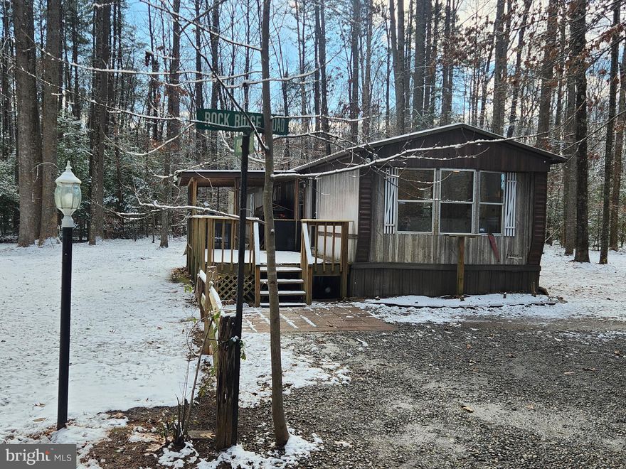 Private. Renovated. Ready.

Set on 5 wooded acres, this move-in ready 3BR, 2BA home delivers quiet, space, and flexibility without giving up comfort. Tucked into a secluded, park-like setting, it’s the kind of place where you hear birds instead of traffic.

Inside, everything that matters has been refreshed. New carpet. New LVP flooring. New stove and refrigerator. New sink, new toilets, new lavatories, new lighting. Updated primary bath with new tub, surround, and fixtures. Washer and dryer convey. Upgraded plywood subfloors for better strength.  Low taxes, No HOA fees and no water bill. The home also features a double-insulated roof with overhang for added efficiency.

Outside is where this property really opens up. A large deck with covered porch invites long evenings outdoors. The oversized carport/pavilion has a brand-new roof. There’s also a finished, insulated garage/man cave with electric, window A/C, and an exterior antenna that pulls Richmond and DC channels. A propane heater could be added easily. New roof here as well.

Two wells on the property, both with pumps. The bored well is currently in use. The drilled well could be reactivated with lining. Switching between wells takes minutes.

A possible Civil War Union trench runs along the back of the land, adding a rare historical touch you won’t find just anywhere.

No loans on the property. Seller may consider owner financing with 50% down, 20-year term at 5.25%. Taxes are just $626 per year.

If you’ve been looking for privacy, land, and real value — this one deserves a closer look.
Schedule your showing today before someone else claims it.