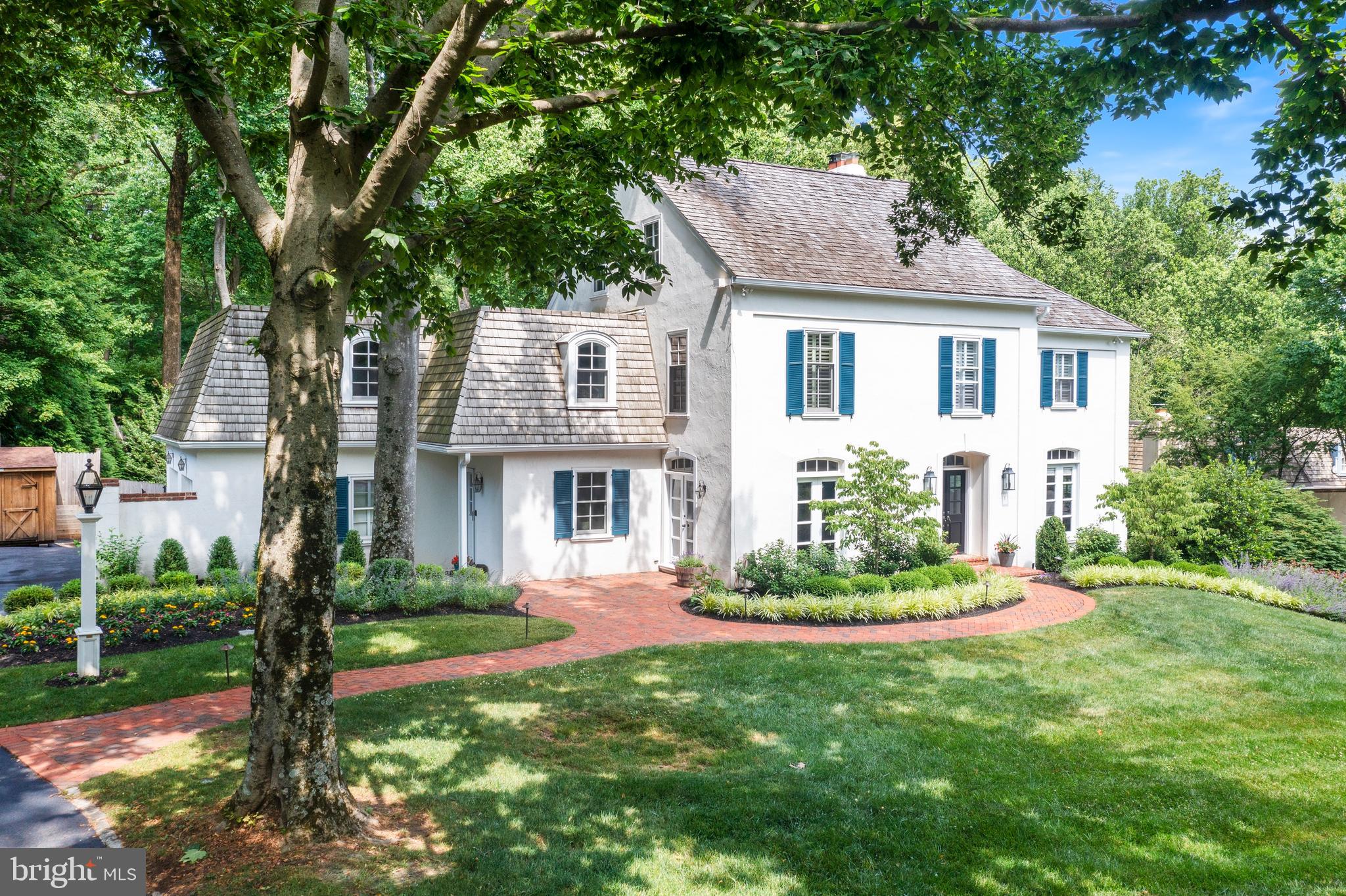 This is the home you’ve been waiting for! Nestled on one of the largest lots and a cul de sac street in the coveted neighborhood of “The Woods”, this updated and expanded French Colonial offers 6 bedrooms and 4.5 baths, plus an array of amenities for the best in Main Line Living.
The elegant exterior seamlessly connects with the beautiful indoor spaces, creating the perfect blend of comfort and tranquility. Upon arrival, you are welcomed to the property by the winding brick walkway to a custom wooden front door with double-pane windows. Upon entering the home you’ll immediately feel the warmness of the hardwood floors, which flow throughout the entire first floor, tasteful crown molding, an abundance of natural light, and two convenient coat closets. Directly off the foyer sits the formal dining room adorned with imposing floor-to-ceiling windows overlooking the front yard, crown molding, wainscoting, chair rail, and a glass French door that provides access to a warm outdoor seating area. Across the foyer is the family room with a striking floor-to-ceiling window, an oversized picture window offering views of the rear yard, and a marble surround wood burning fireplace flanked by two custom wooden built-ins. A bright and airy breakfast room sits snug in the rear of the home, decorated with a brick surround gas fireplace, a custom walnut-topped built-in desk, a quaint eating area with a picturesque view of the rear yard, built-in shelving, and a vaulted ceiling. Prepared to be wowed by the recently expanded gourmet chef’s kitchen equipped with polished soapstone countertops, a substantial walnut-topped center island with a prep sink and microwave built-in, a La Cornue range with a handcrafted walnut Zephyr hood, a Wolf wall oven, Aston Black recessed door white cabinets, two miele dishwashers, white washed brick backsplash, a walk-in pantry, a butler’s pantry/coffee bar, and french doors that lead to the expansive brick and flagstone patio. A sizable mudroom sits right off the kitchen, with cherry cubbies, built-in storage, granite-topped work center, stone flooring, and opportune access to the attached two-car garage.
Take the front-turned wooden staircase to the second floor and make your way to the primary suite detailed with a large picture window overlooking the rear yard, two walk-in closets, and an intimate reading nook with custom built-in bookshelves. The exclusive ensuite bath features a marble-topped double vanity, a seamless glass shower, and a linen closet. Three additional bedrooms can be found on this floor, each with hardwood floors and ample closet space. Two bedrooms share the use of a full hall bathroom, with the third bedroom enjoying a private ensuite bathroom. Rounding out the second floor is a laundry room with herringbone flooring, a sink, and storage. The sizable third level of this home hosts the final two spacious bedrooms, with their own allocated full-hall bathroom.
The daylight walk-out basement is equipped with an entertaining area, plenty of space to accommodate a fitness studio, and an abundance of storage. Last but certainly not least, exit the home through the glass French doors in the kitchen to the private rear property which is an oasis for gatherings, ideally set up with a custom brick and flagstone patio, an in-ground swimming pool with a flagstone deck and retractable cover, and multiple sitting areas to soak up the summer sun.
The “Woods” is an exceptional neighborhood with block parties, progressive dinners, and two cul de sacs where children can ride their bikes. This premier location provides easy access to the Village of Wayne and its upscale shops and restaurants, and the Radnor and Wayne train stations. Award-winning Radnor Schools!!
Showings begin Friday June 16th at the Open House 1-3PM